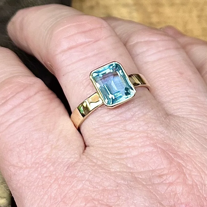 Ownwers recycled gold ring with emerald cut topaz