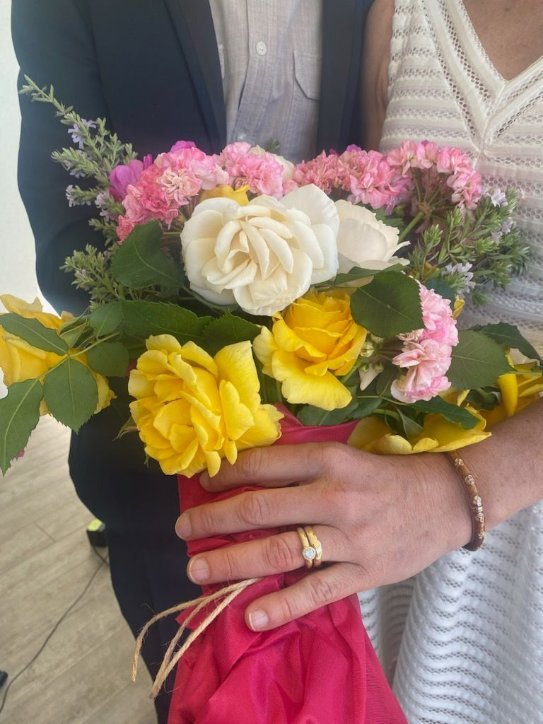 The bride wearing their custom made rings. Wedding ring ring and engagement ring in 14k gold with yellow white diamond.