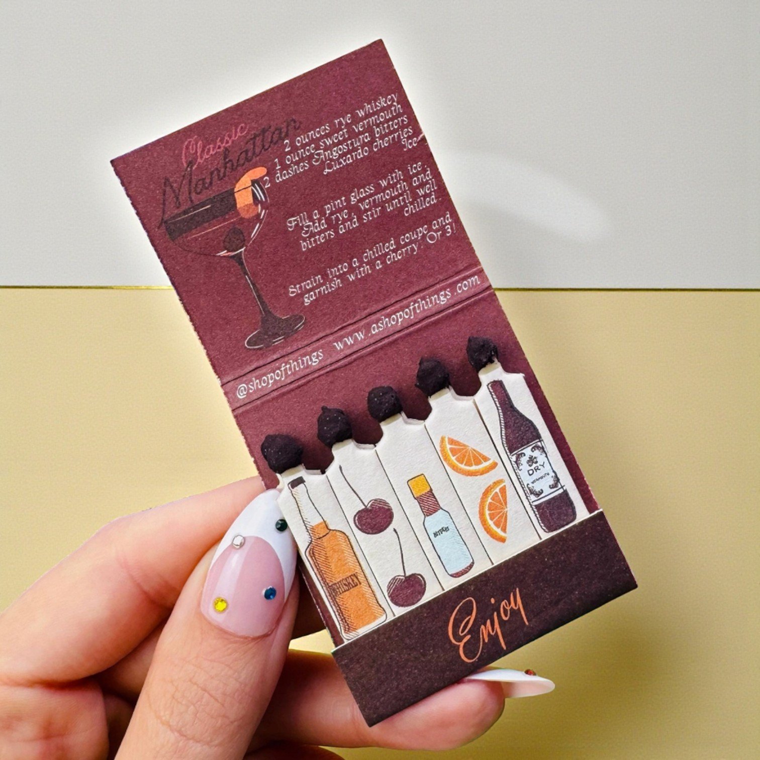 Vintage cocktail matchbook inspired by the Manhattan drink, featuring moody color and bar art.