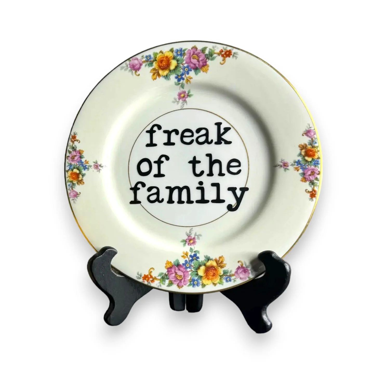 Humorous decorative plate featuring a floral design and bold family statement for quirky home decor.