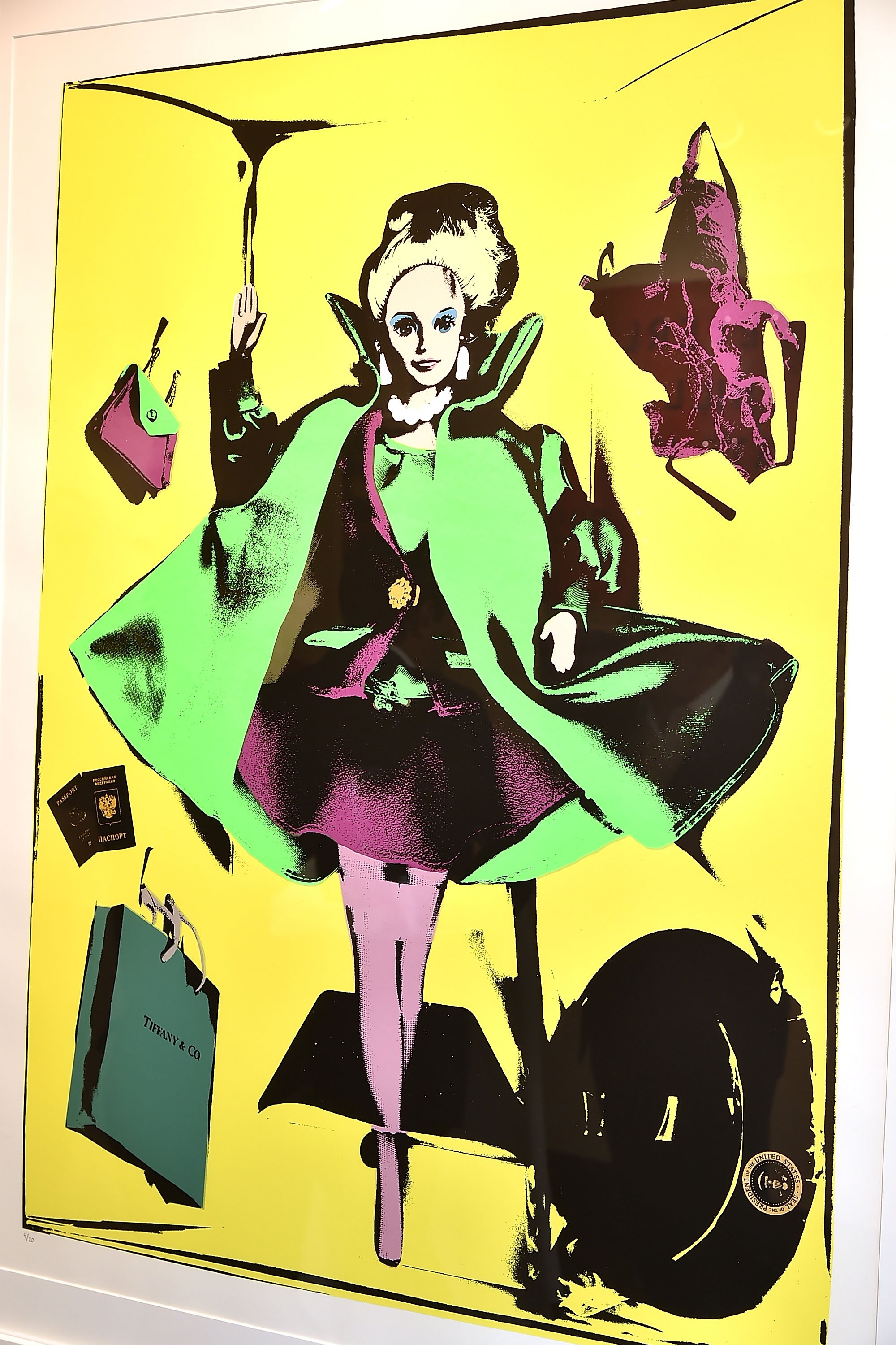 Pop art screenprint featuring a stylized doll with platinum hair, dressed in a green and purple outfit against a vibrant yellow background. Surrounding the doll are items like a pink handbag, purple lingerie, and a Tiffany & Co. shopping bag.