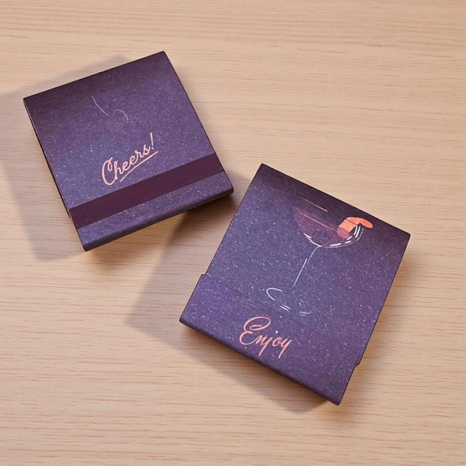 Whiskey-themed mini matchbook with stylized alcohol bottles and rich burgundy background.