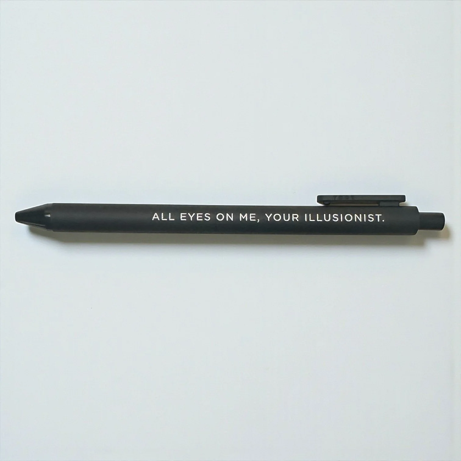 Taylor Swift gel pen from Reputation collection with moody lyric printed on a matte black barrel.