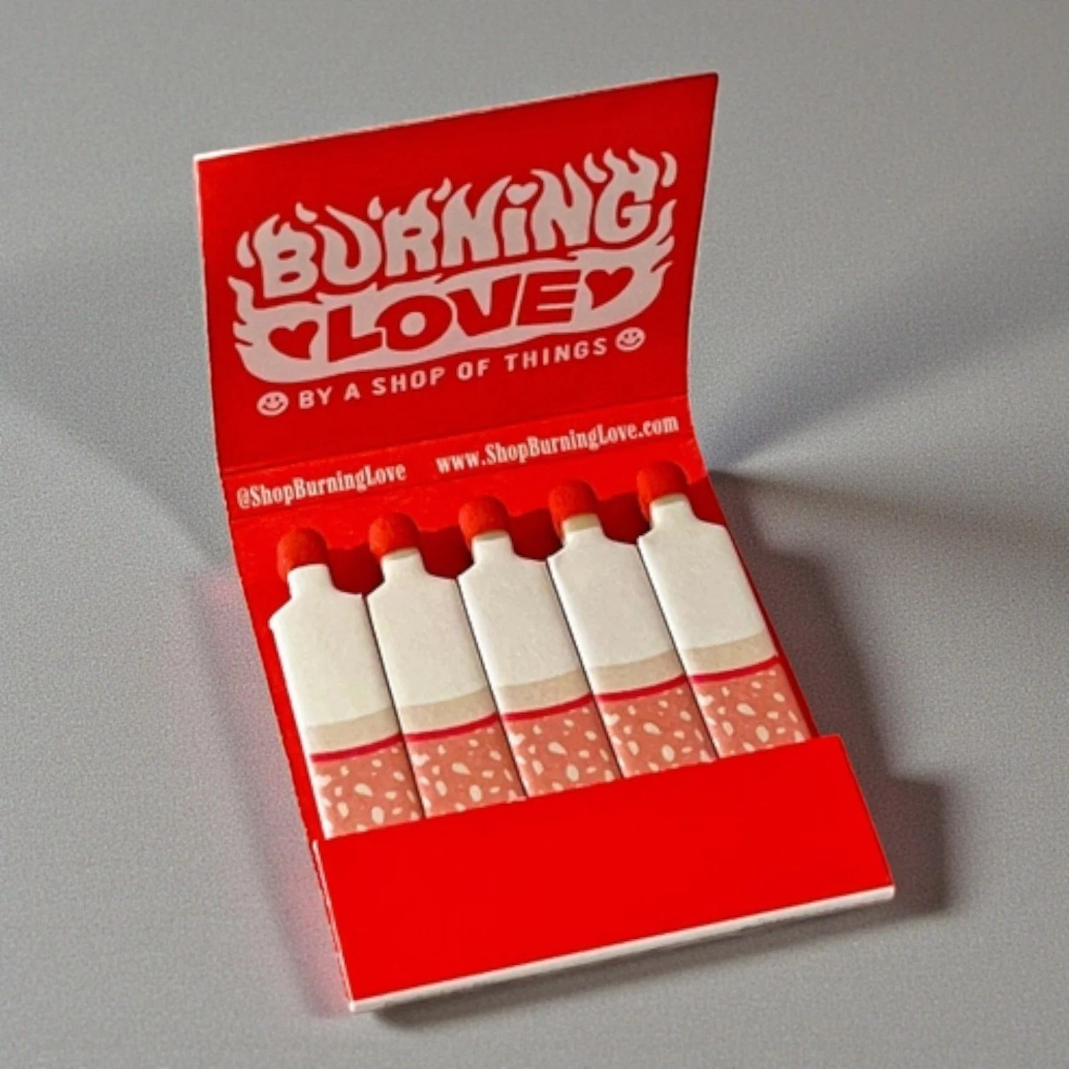 Funny “Burning Love” matchbook styled like a vintage cigarette pack, perfect as a cheeky gift or decor.