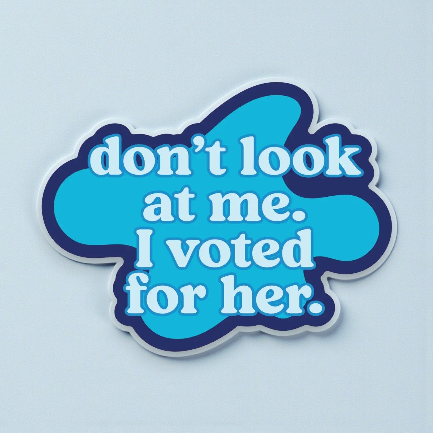 Blue sticker with retro design that reads “Don’t look at me. I voted for her.” – feminist political message.