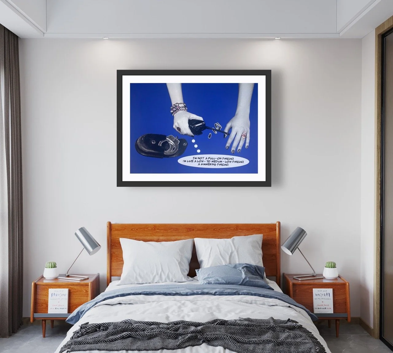 Framed art piece of a two hands above a speech bubble reading "I'm not a full-on psycho. I'm like a low to medium-low psycho. A simmering psycho" hung above a bed.