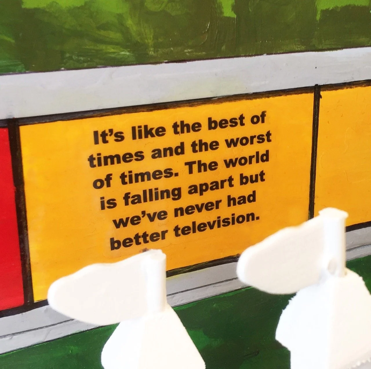 Game of LIFE tile with the text, "It’s like the best of times and the worst of times. The world is falling apart but we’ve never had better television." 