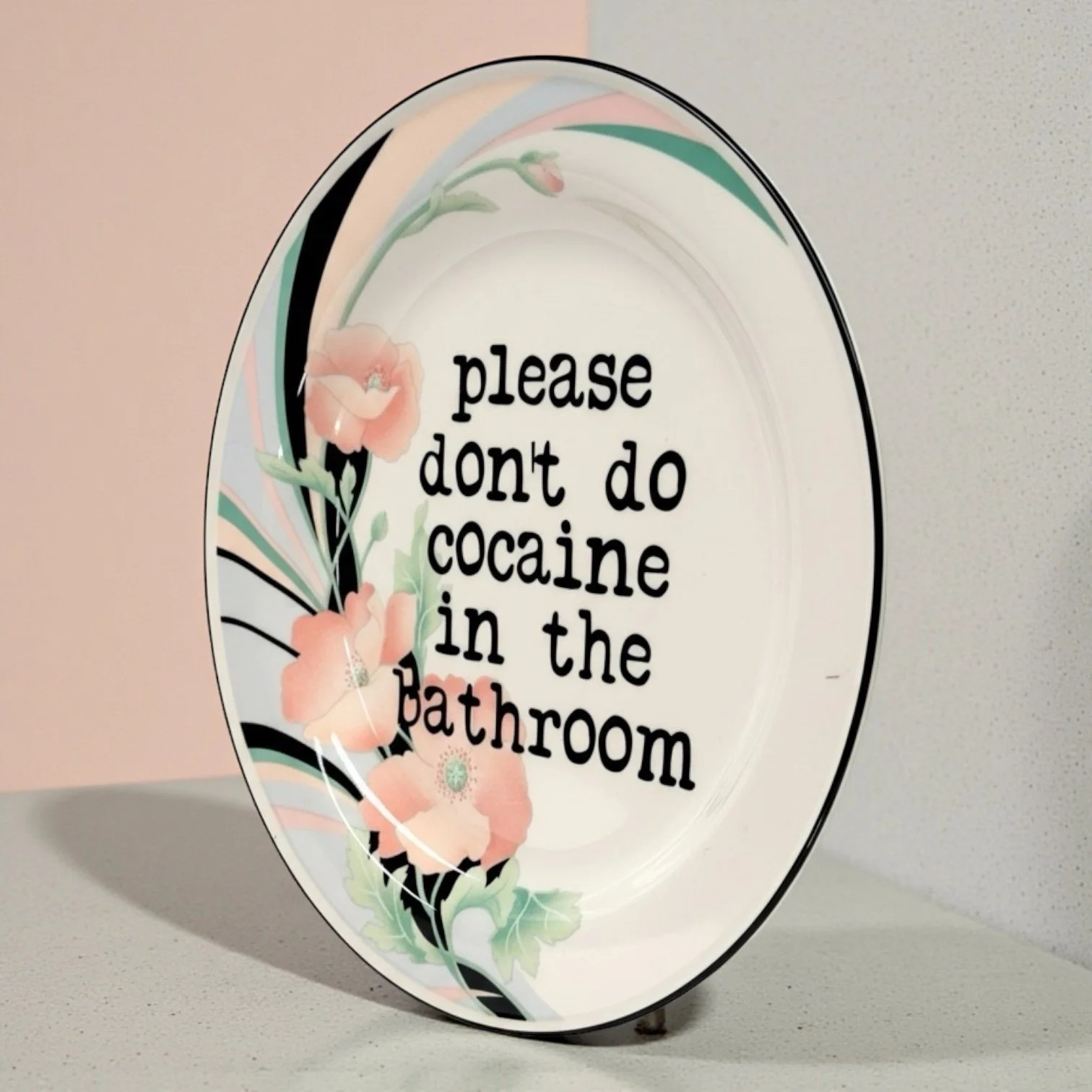 Funny decorative plate with vintage pastel flowers and satirical drug warning quote.