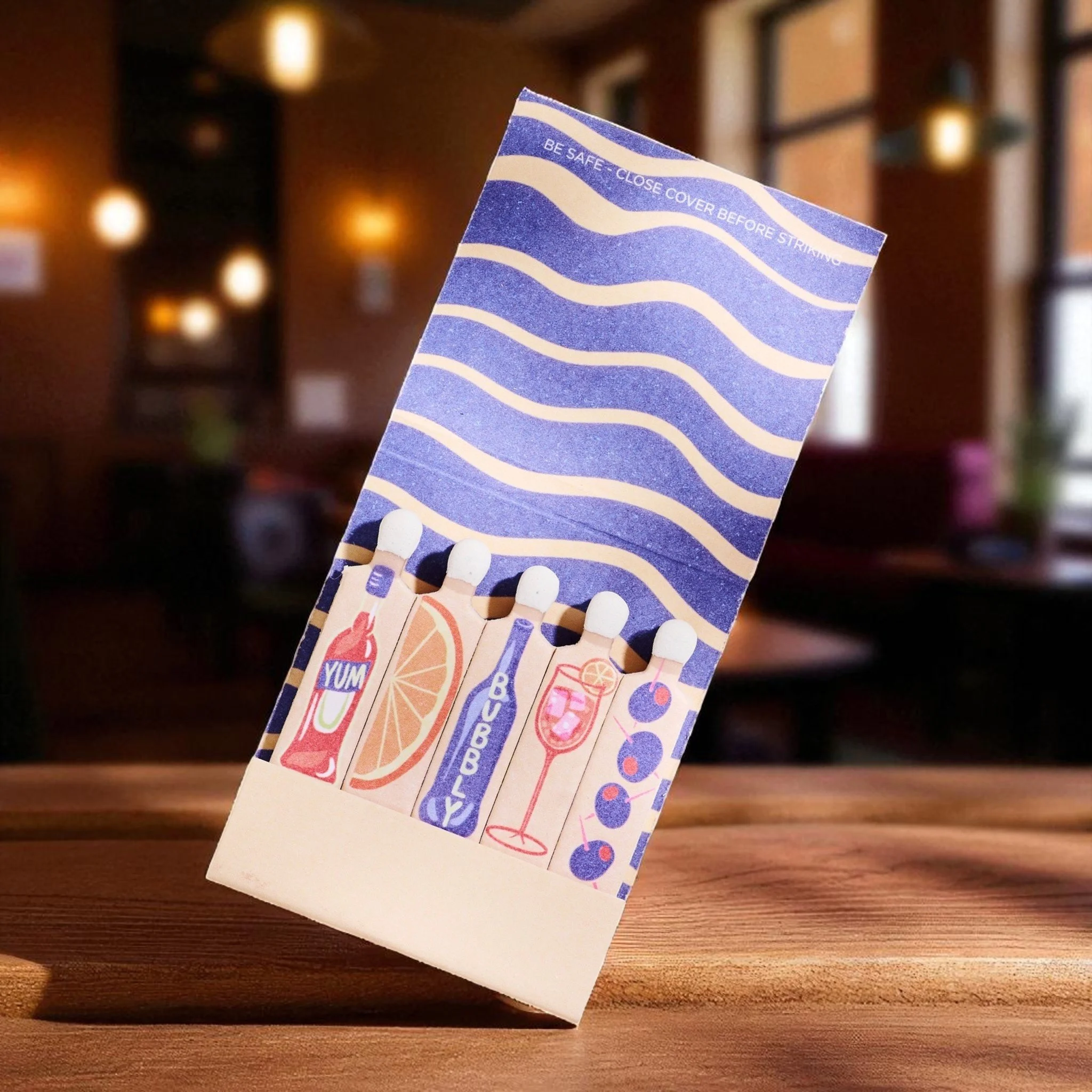 Cocktail matchbook featuring Aperol Spritz illustrations of bubbly, orange, and glass.