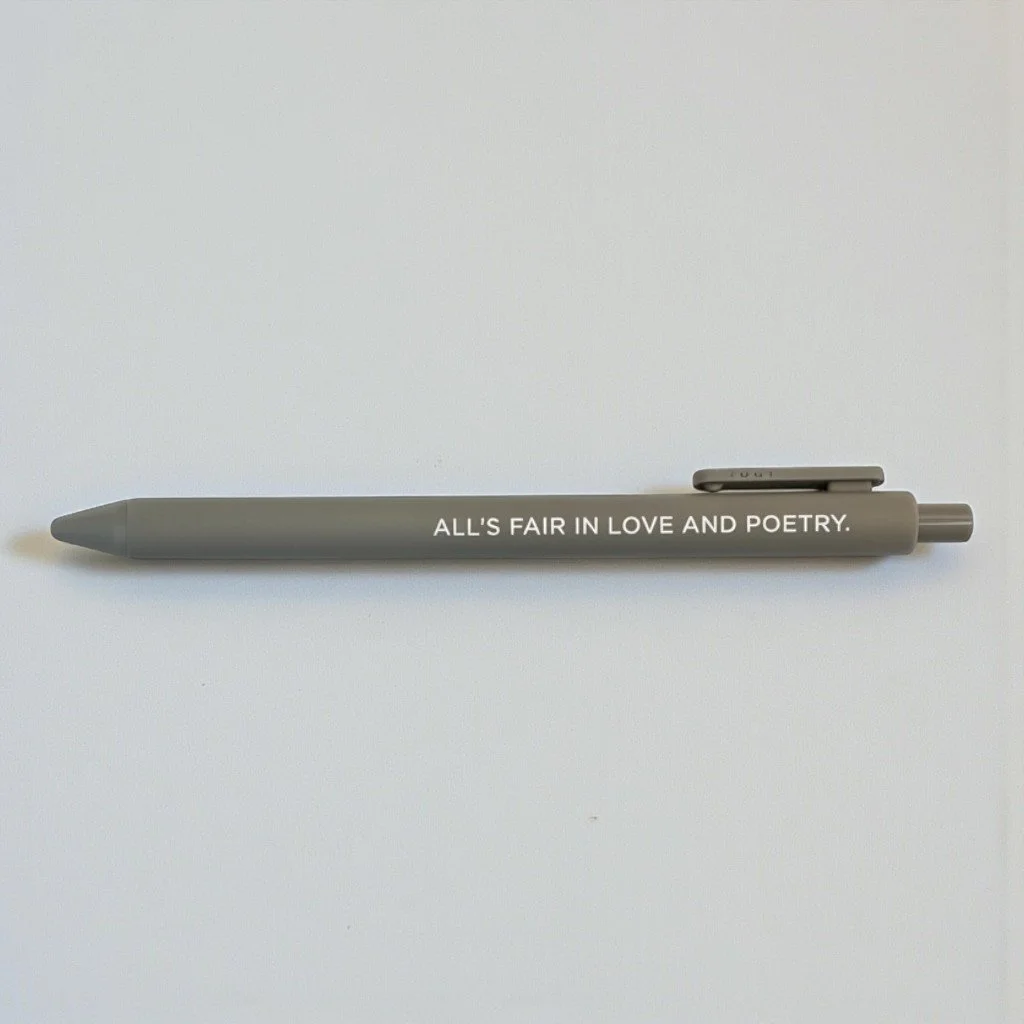 Swiftie-themed gray jotter pen with “ALL’S FAIR IN LOVE AND POETRY” printed in white text for TTPD fans.