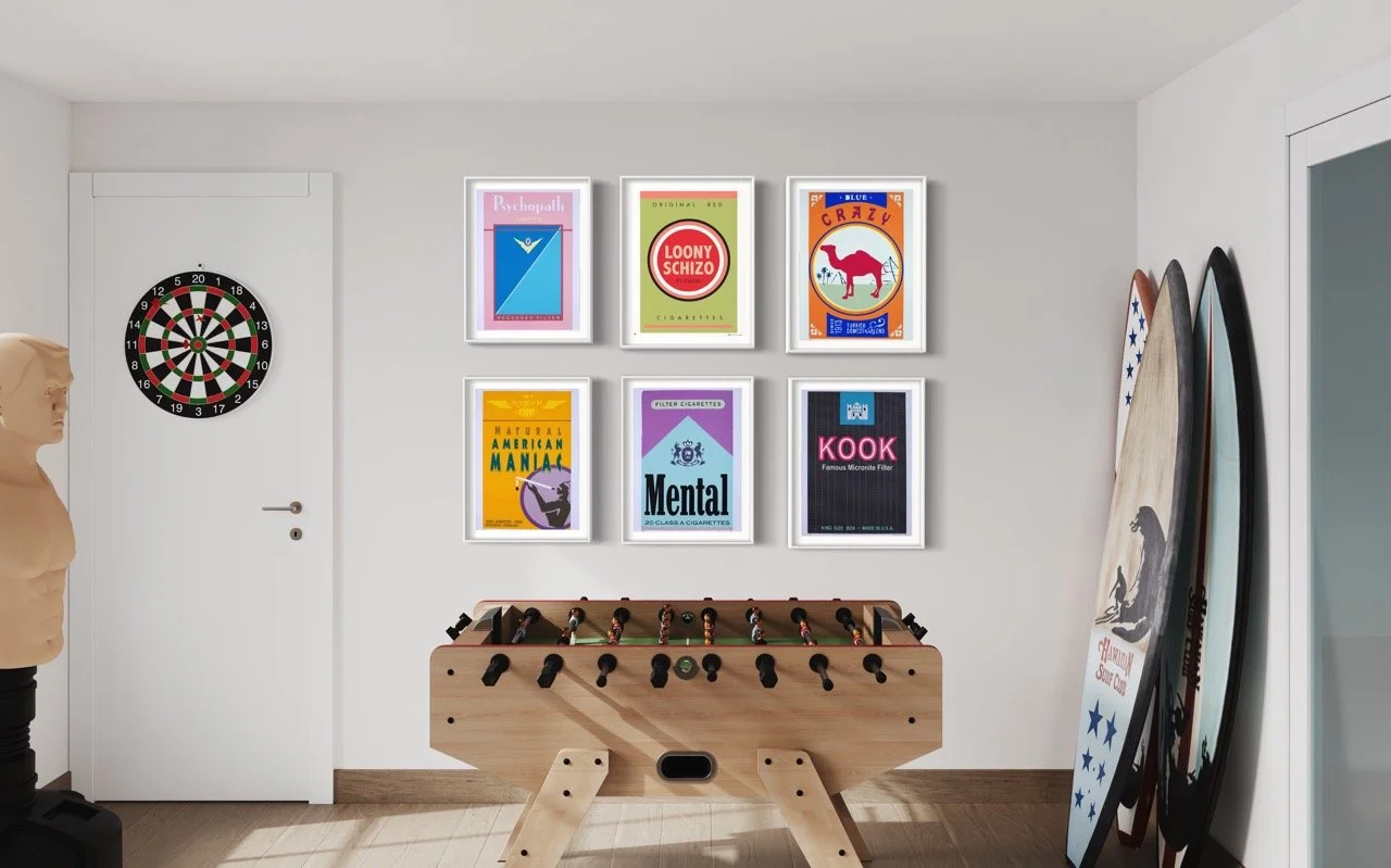 Six reimagined cigarette packaging art pieces hanging above a pool table with surfboards and a dart board.