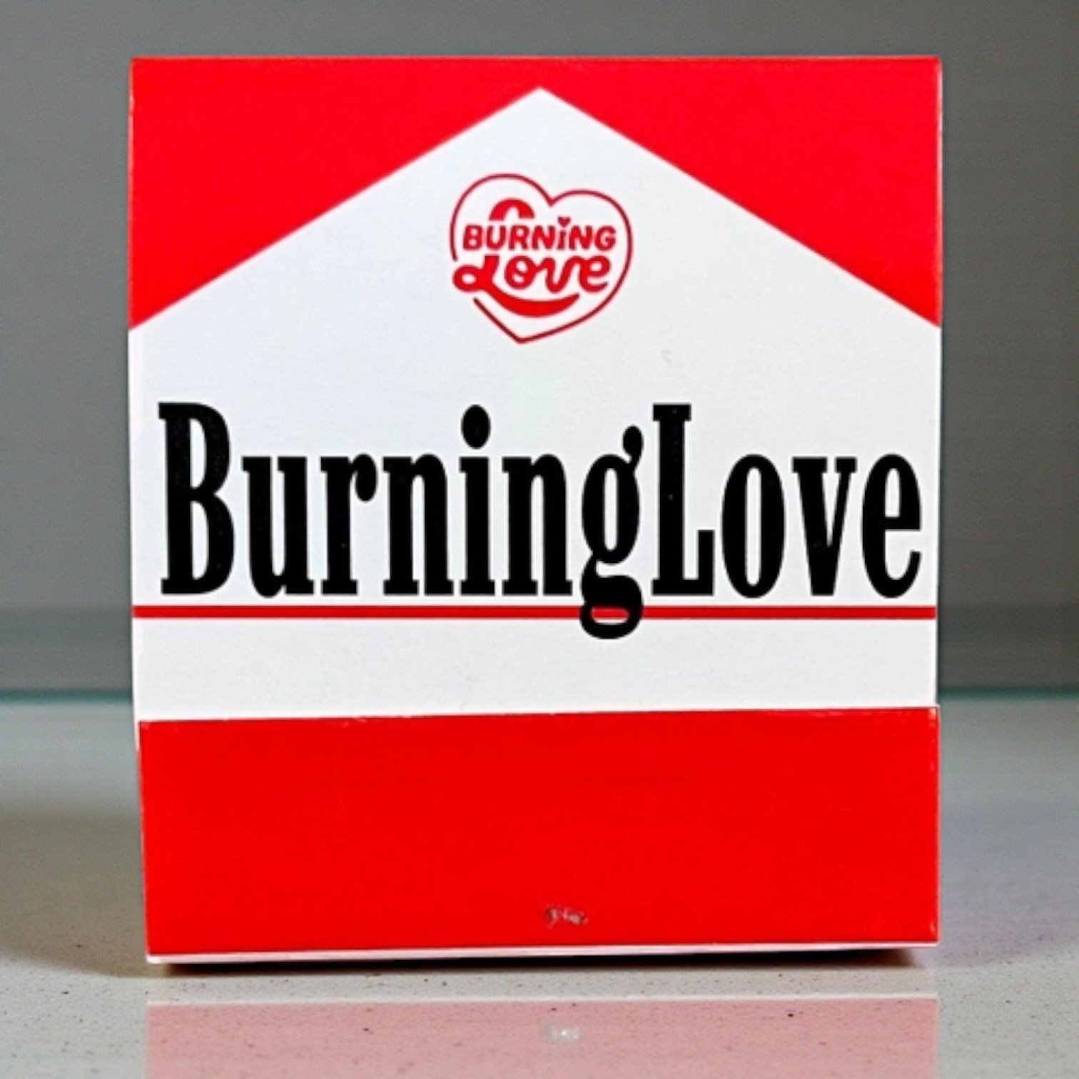 Red and white matchbook with “Burning Love” text in bold, pop-art inspired design with romantic twist.