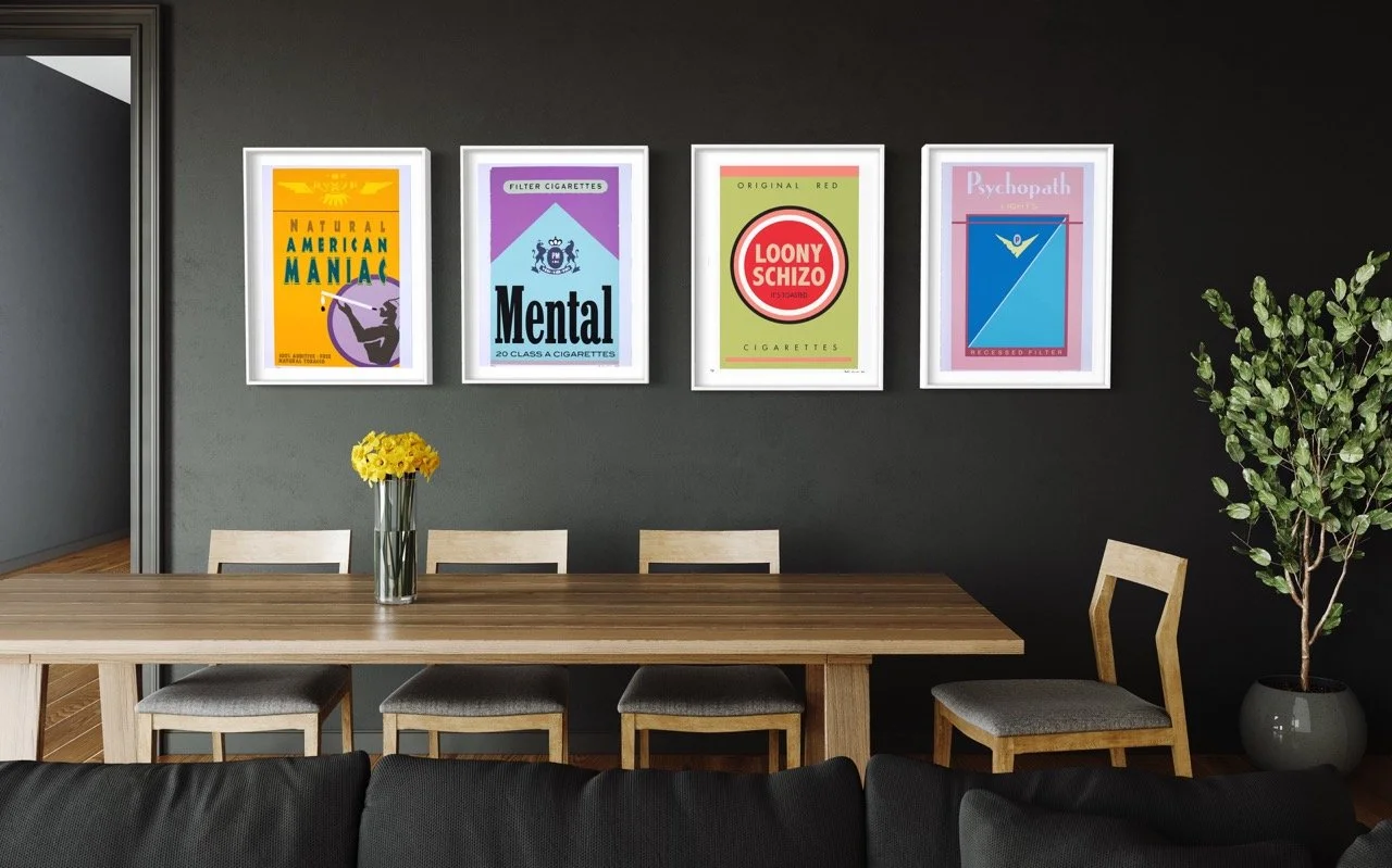 Four framed silkscreen prints displayed on a dark wall, resembling vintage cigarette pack designs with satirical titles and graphics. Each artwork features unique graphics and typography related to its title.