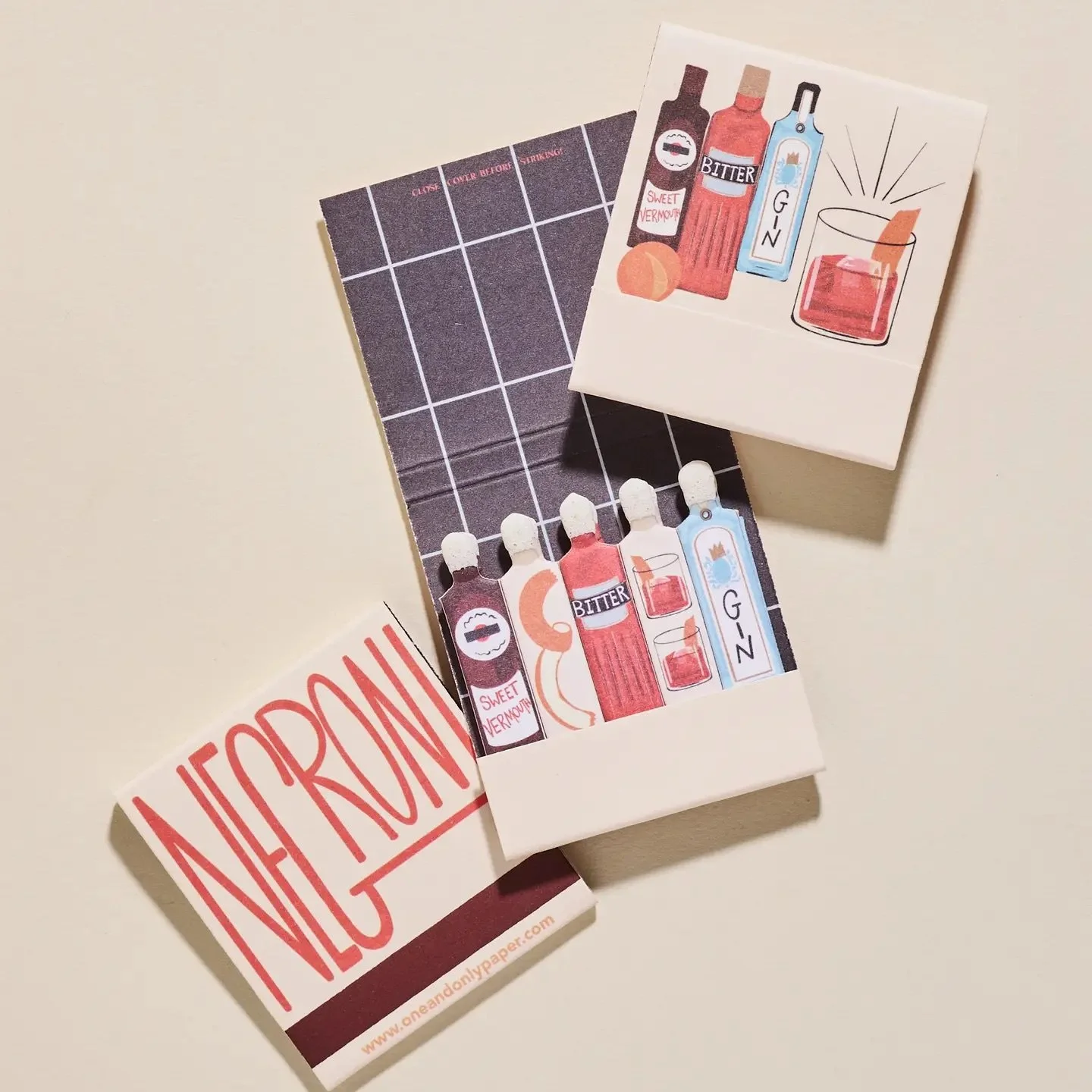 Illustrated Negroni matchbook featuring bottles of gin, sweet vermouth, and bitter with cocktail artwork.