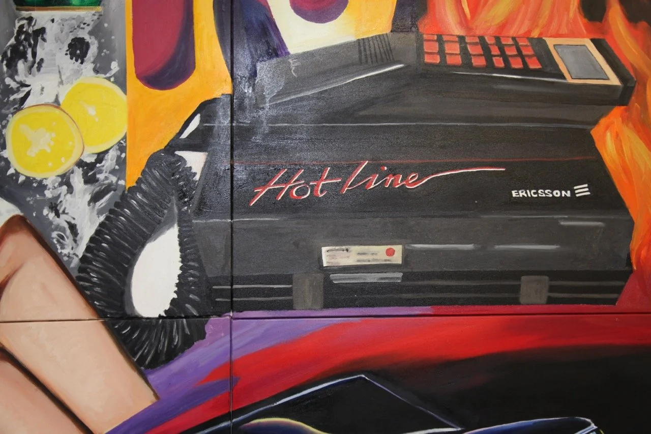 Colorful artwork highlighting an Ericsson Hotline phone, with vivid lemon slices and splashes of water in the background.