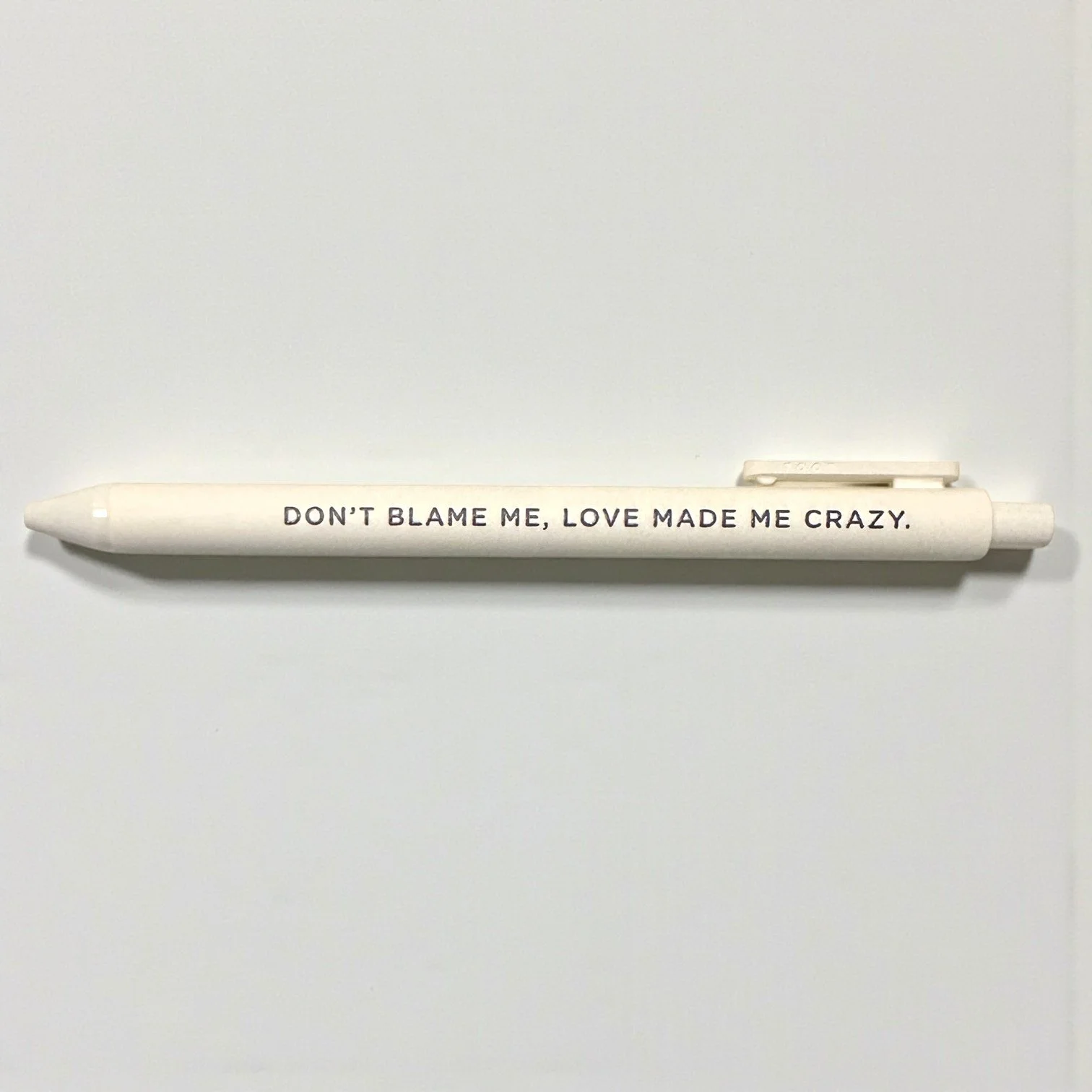 Cream gel pen with the lyric “Don’t blame me, love made me crazy.” printed in black — inspired by Taylor Swift’s Reputation album.