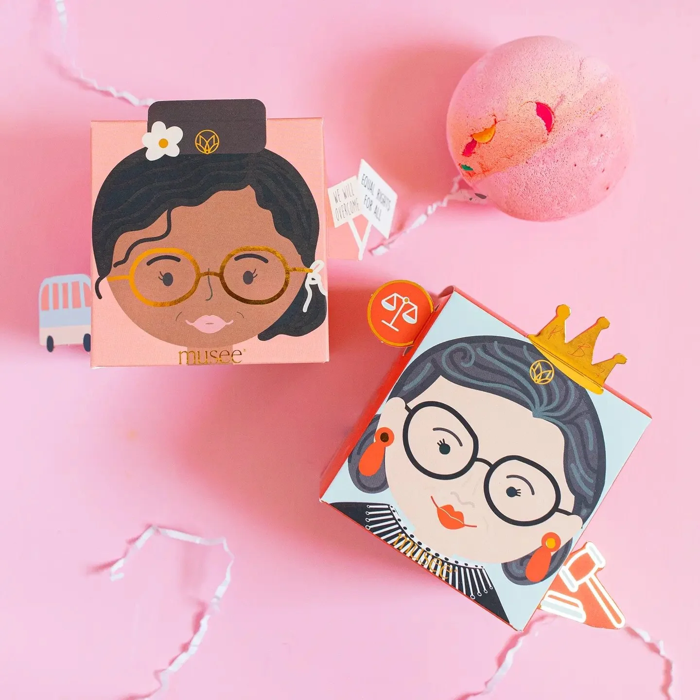 Whimsical bath bomb packaging inspired by historic women, including RBG and Rosa Parks.