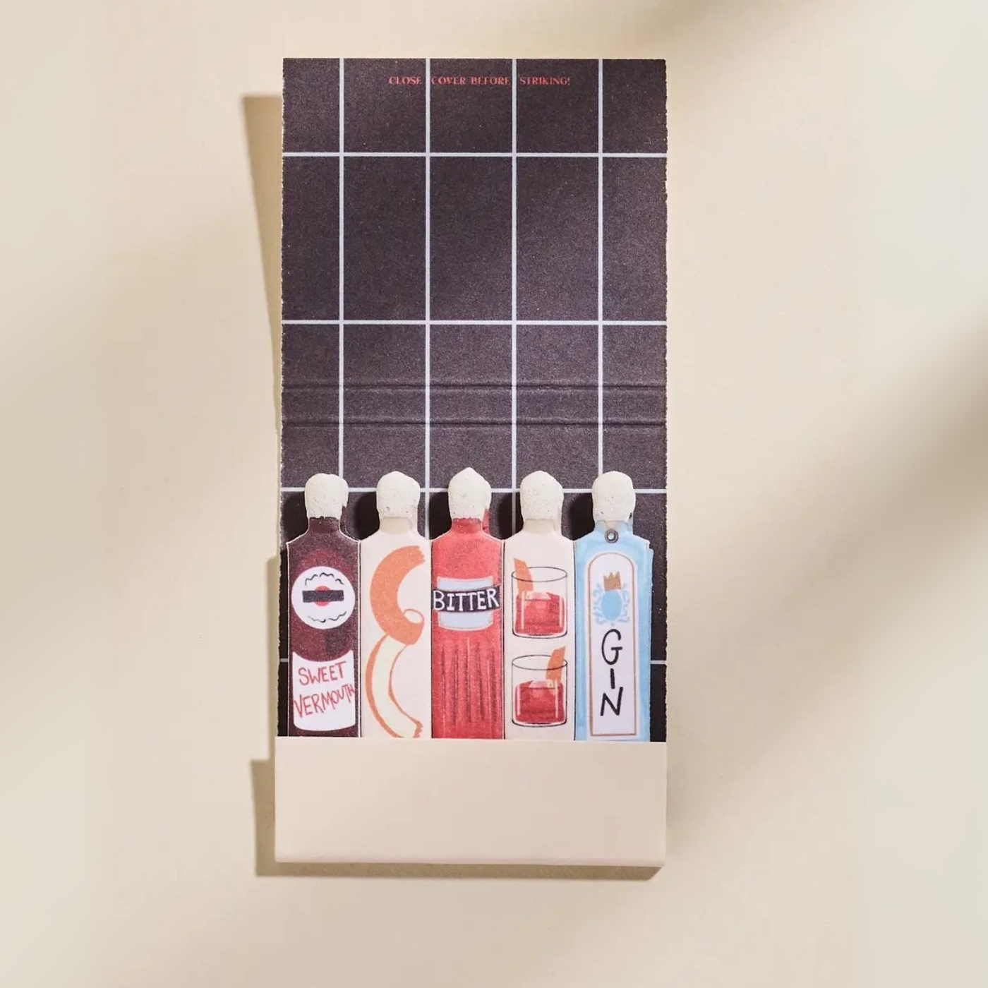 Negroni matchbook with illustrated bottles of sweet vermouth, bitter, gin, and cocktail glasses.