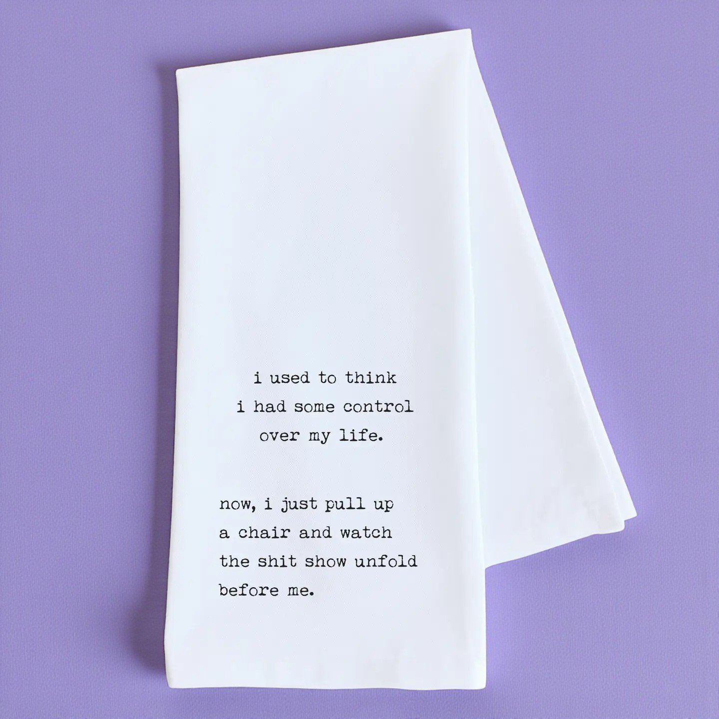 Printed tea towel with quote reading “watch the sh*t show unfold,” ideal for adult humor lovers.