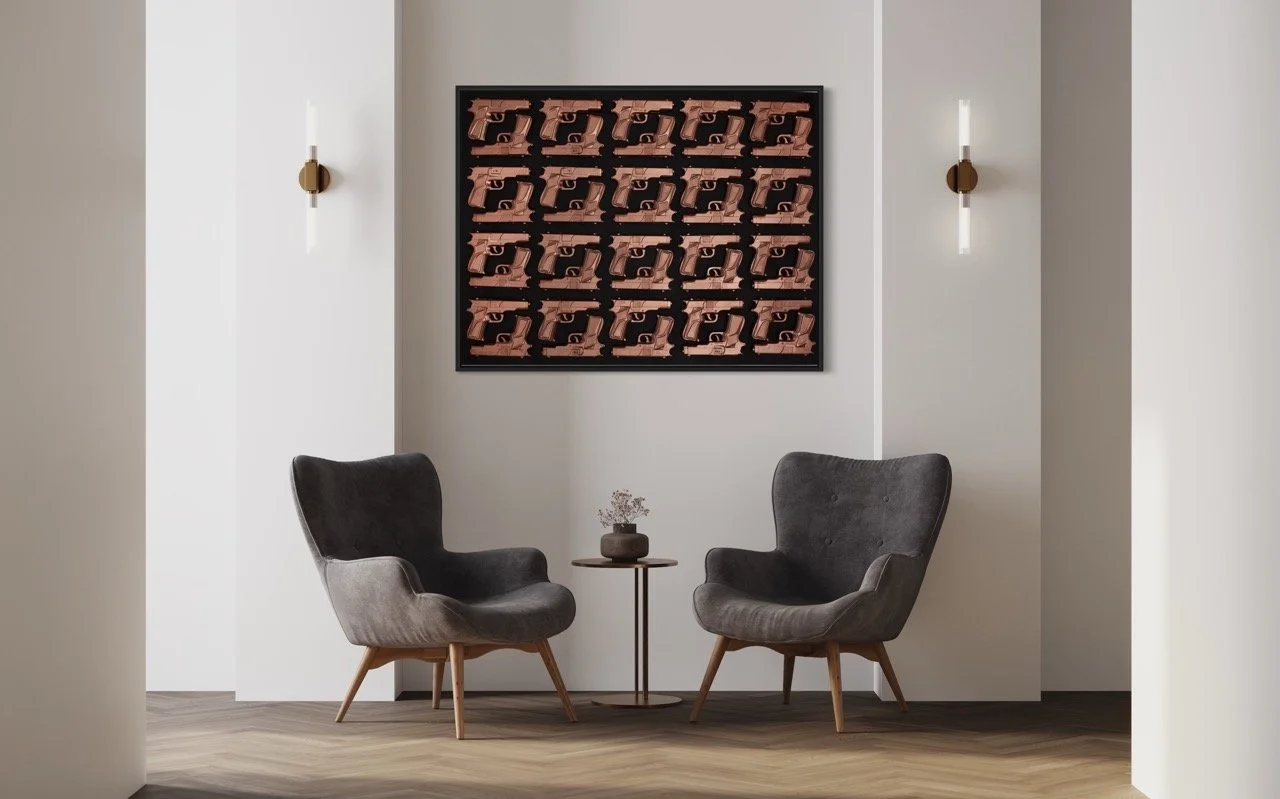 "Minimalist seating area featuring two gray armchairs and a small round table between them. A large pop art piece of brown pistols arranged in a grid on a black background hangs on the wall. Modern wall sconces add a touch of elegance to the space.
"