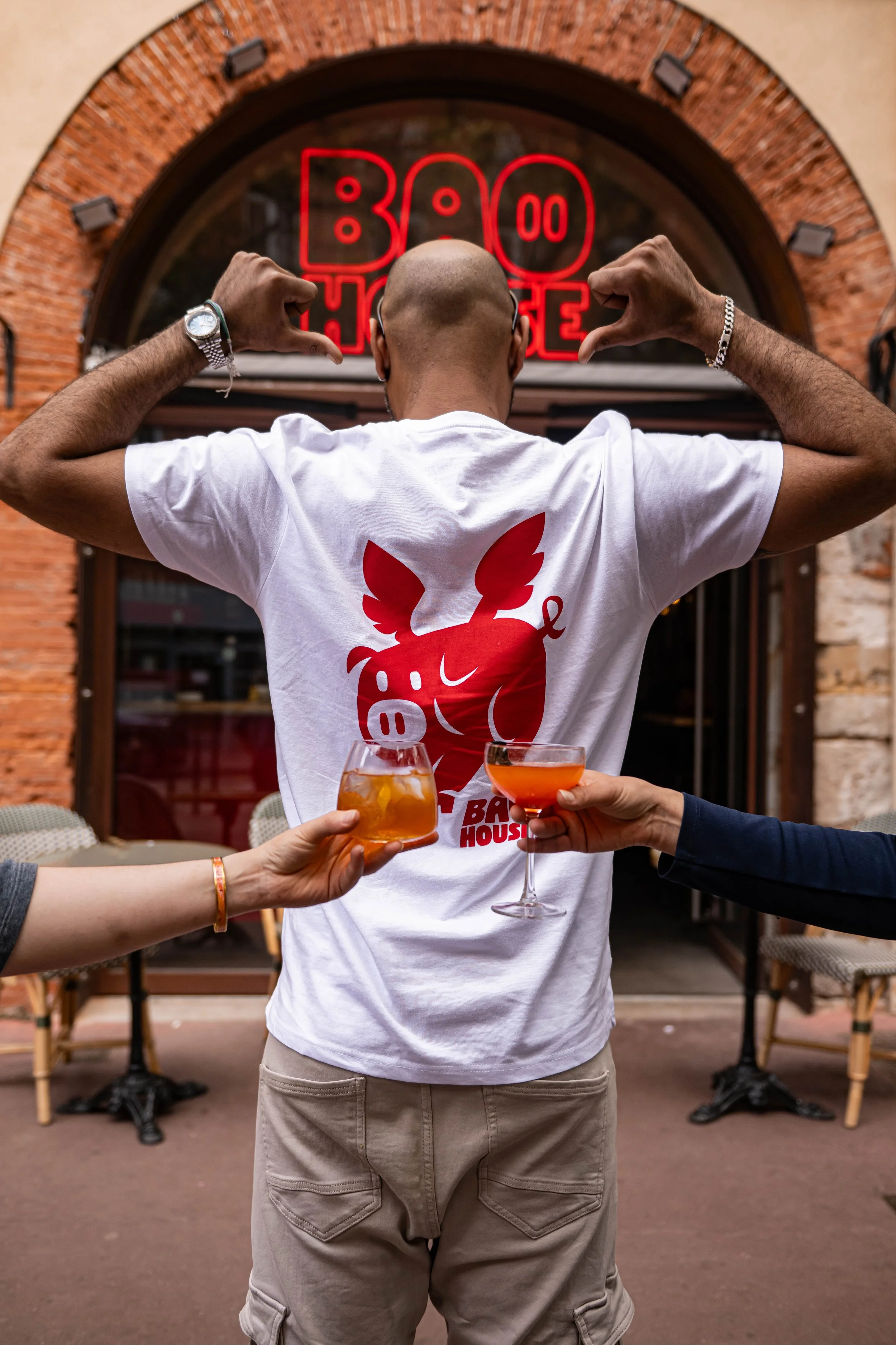 Client trinquant en terrasse devant Bao House, restaurant du groupe Guilty Kitchen Concept à Toulouse