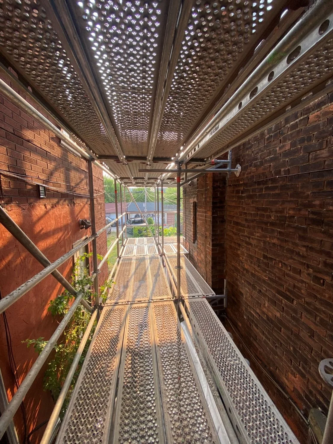 View of side access construction scaffold on Toronto brick home restoration