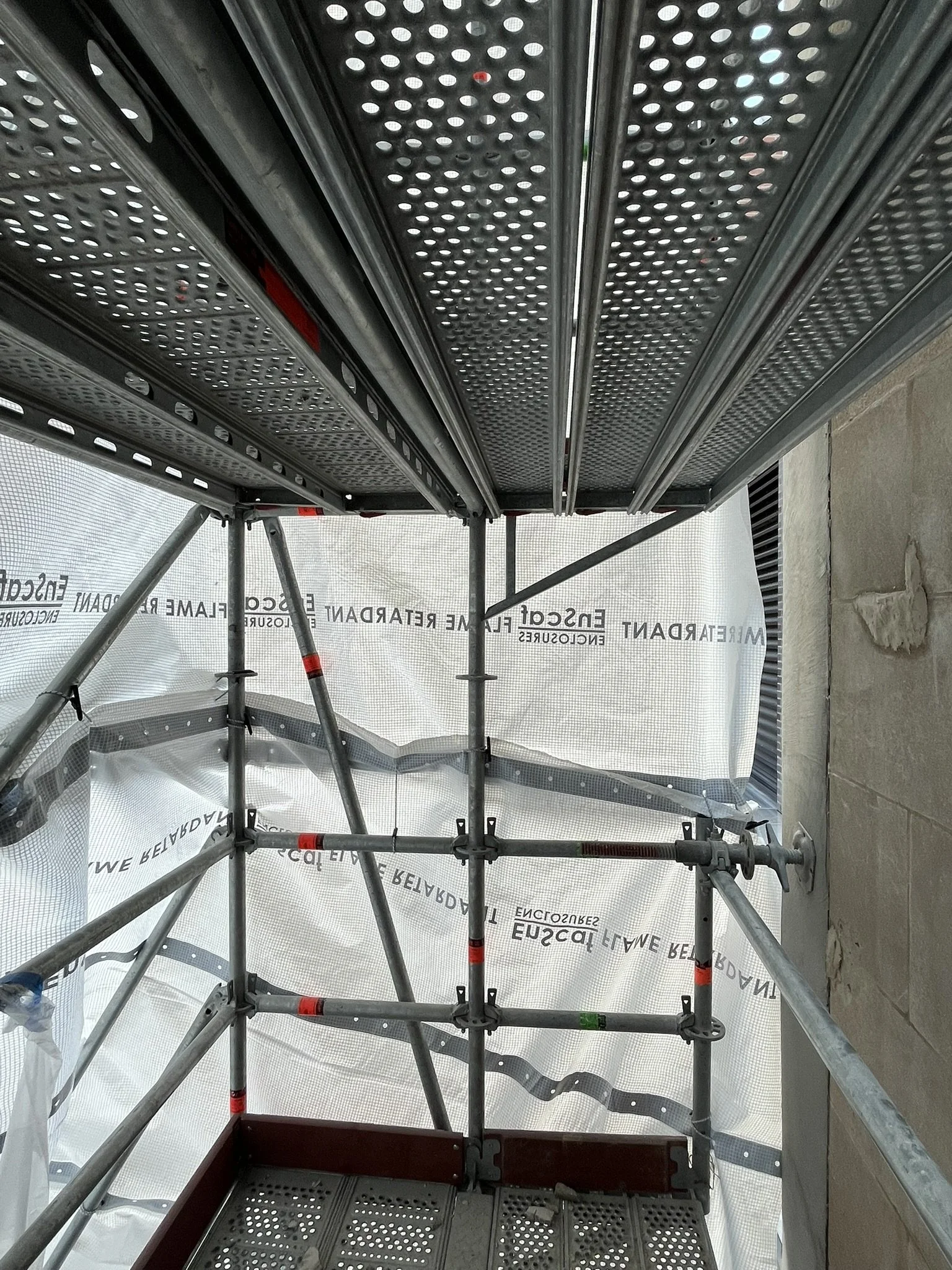 Interior view of scaffold wrapping with white tarp