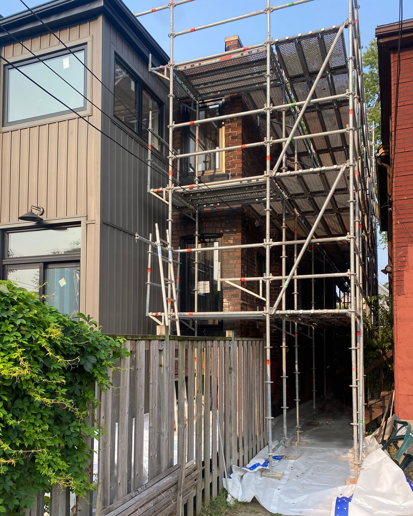 Side access scaffolding for narrow space access for new home construction in Toronto