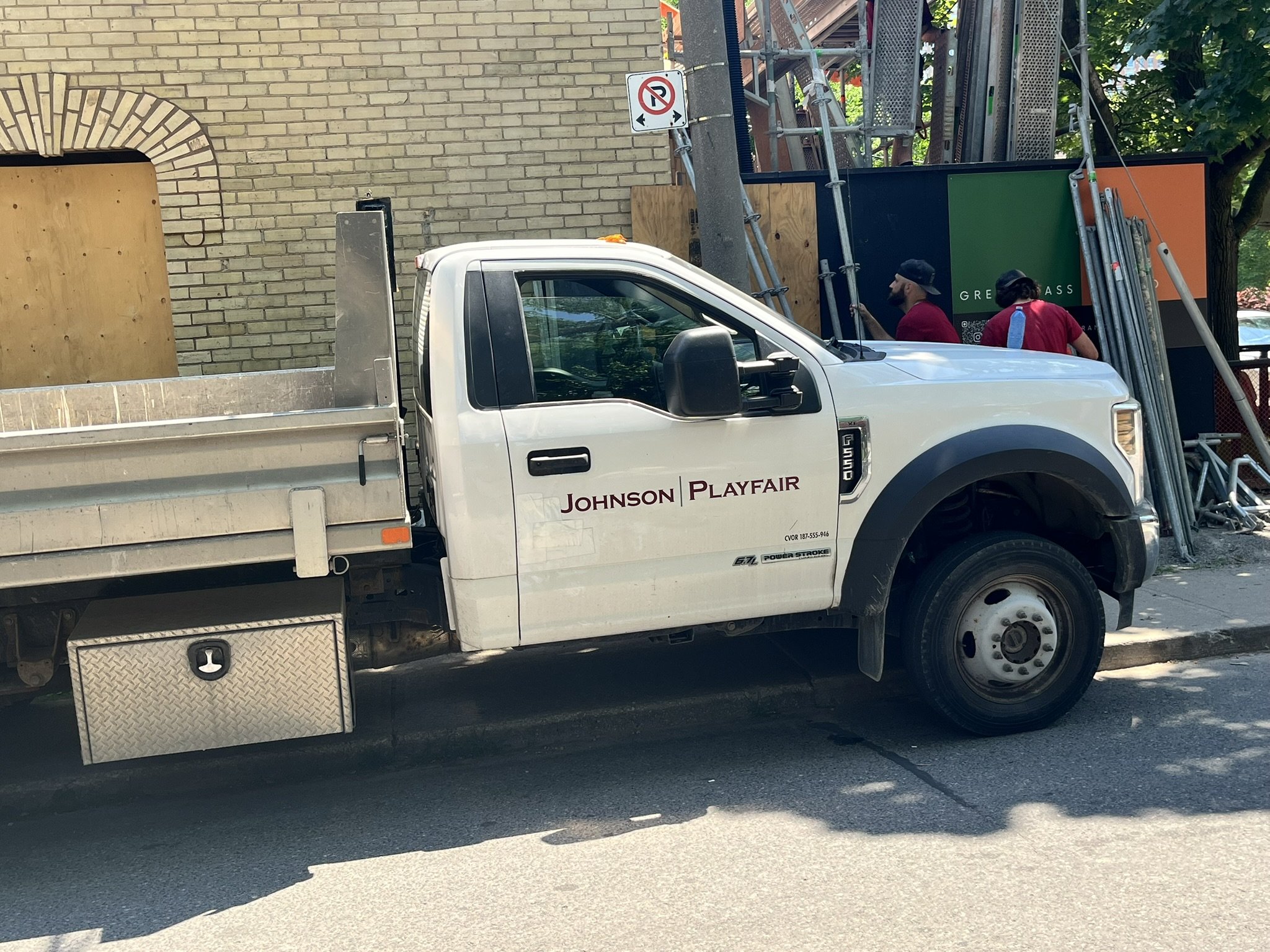 Scaffold truck parked on a Toronto street with crew behind