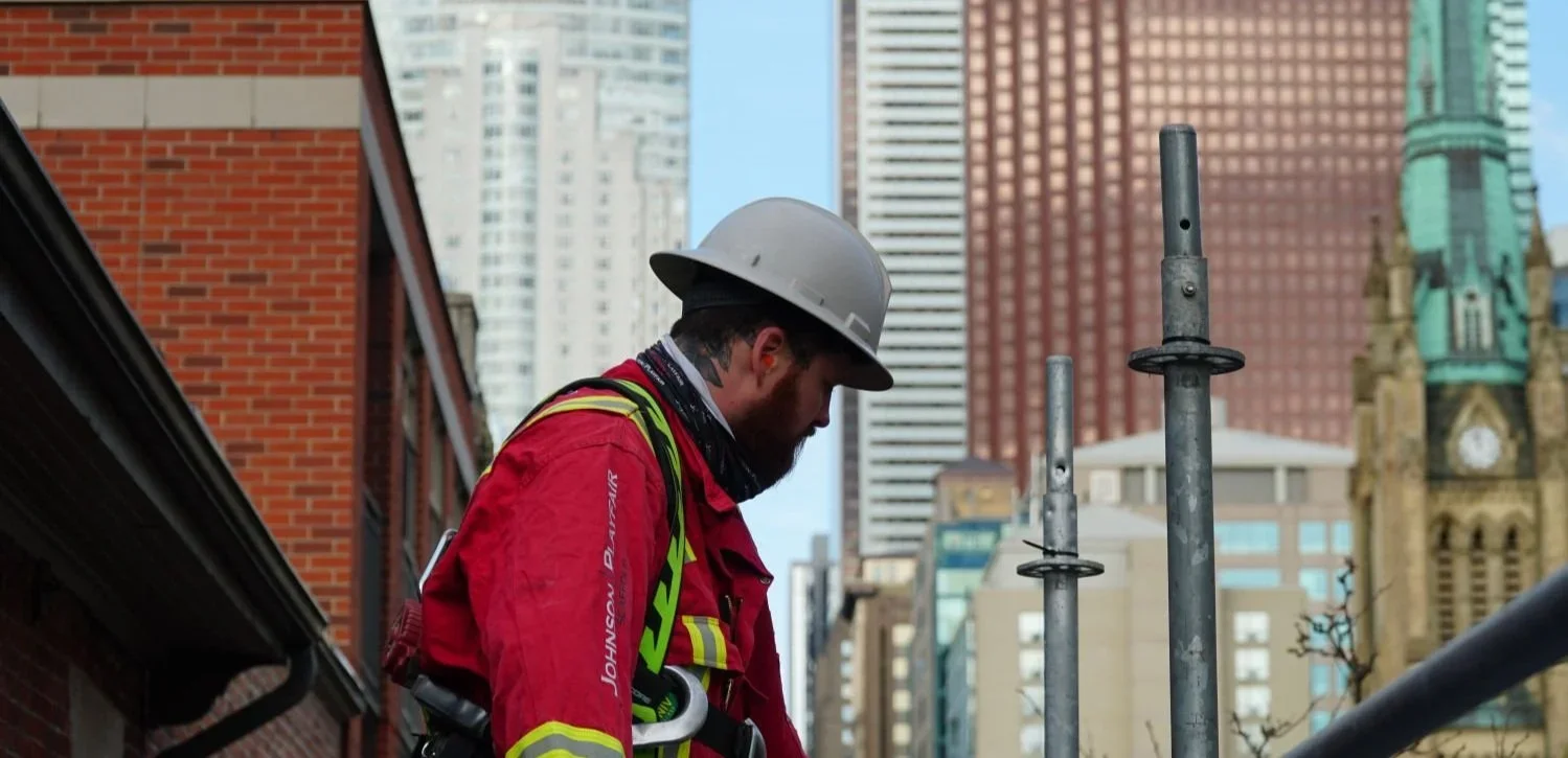 Johnson Playfair scaffolder installing scaffolding in downtown Toronto
