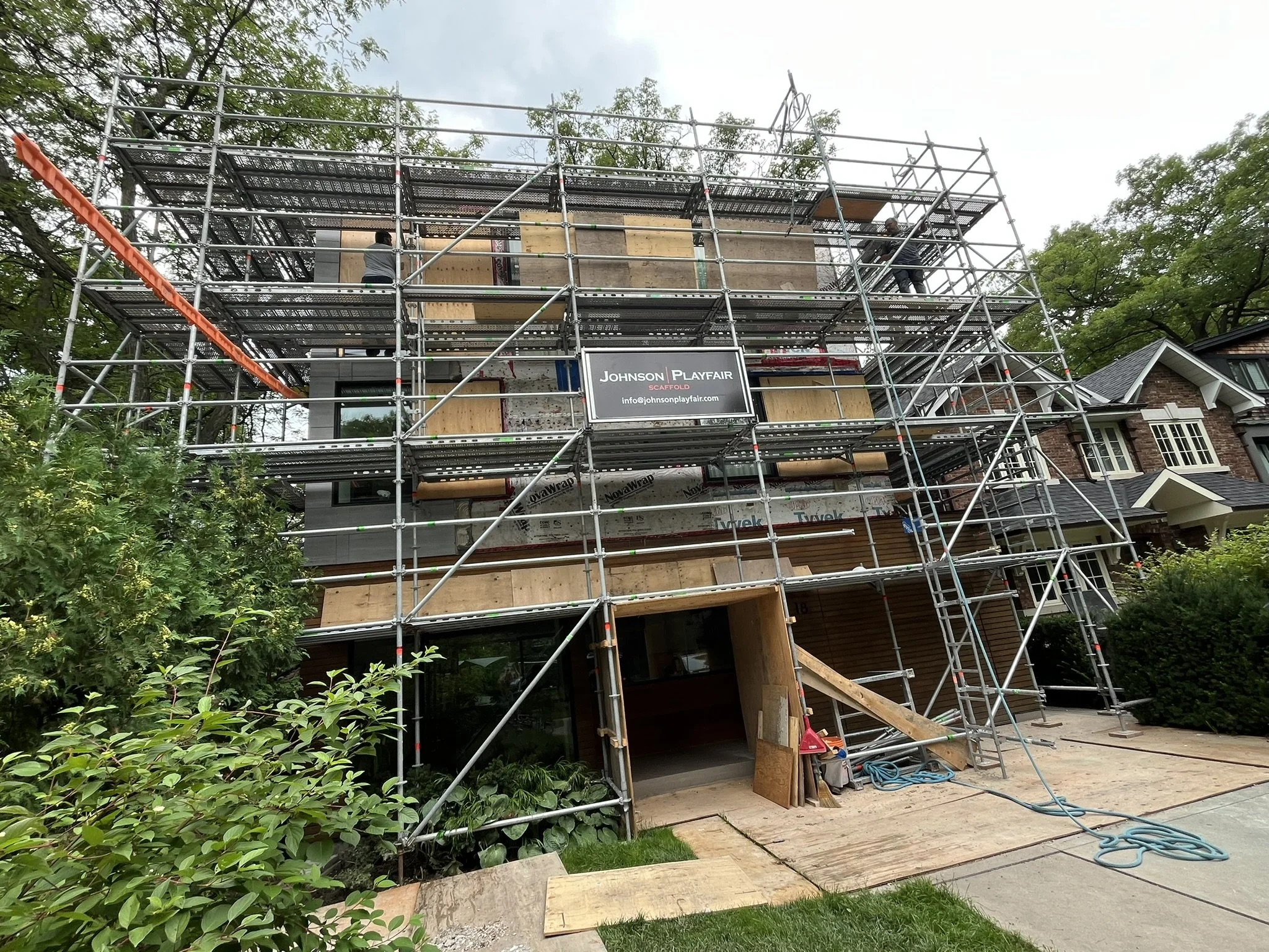 System scaffolding in front of a Toronto home with a Johnson Playfair Scaffold sign