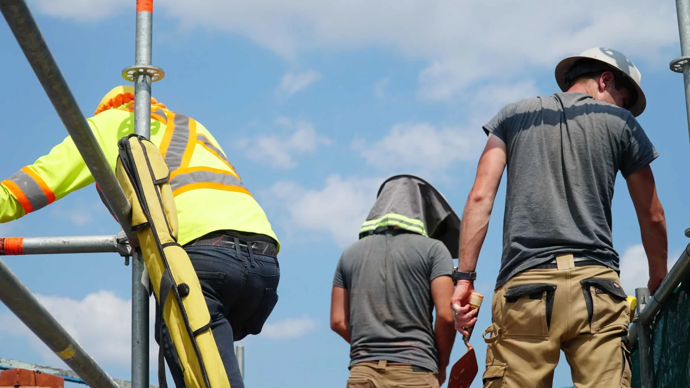 Johnson Playfair crew working on a scaffold on a sunny summer day
