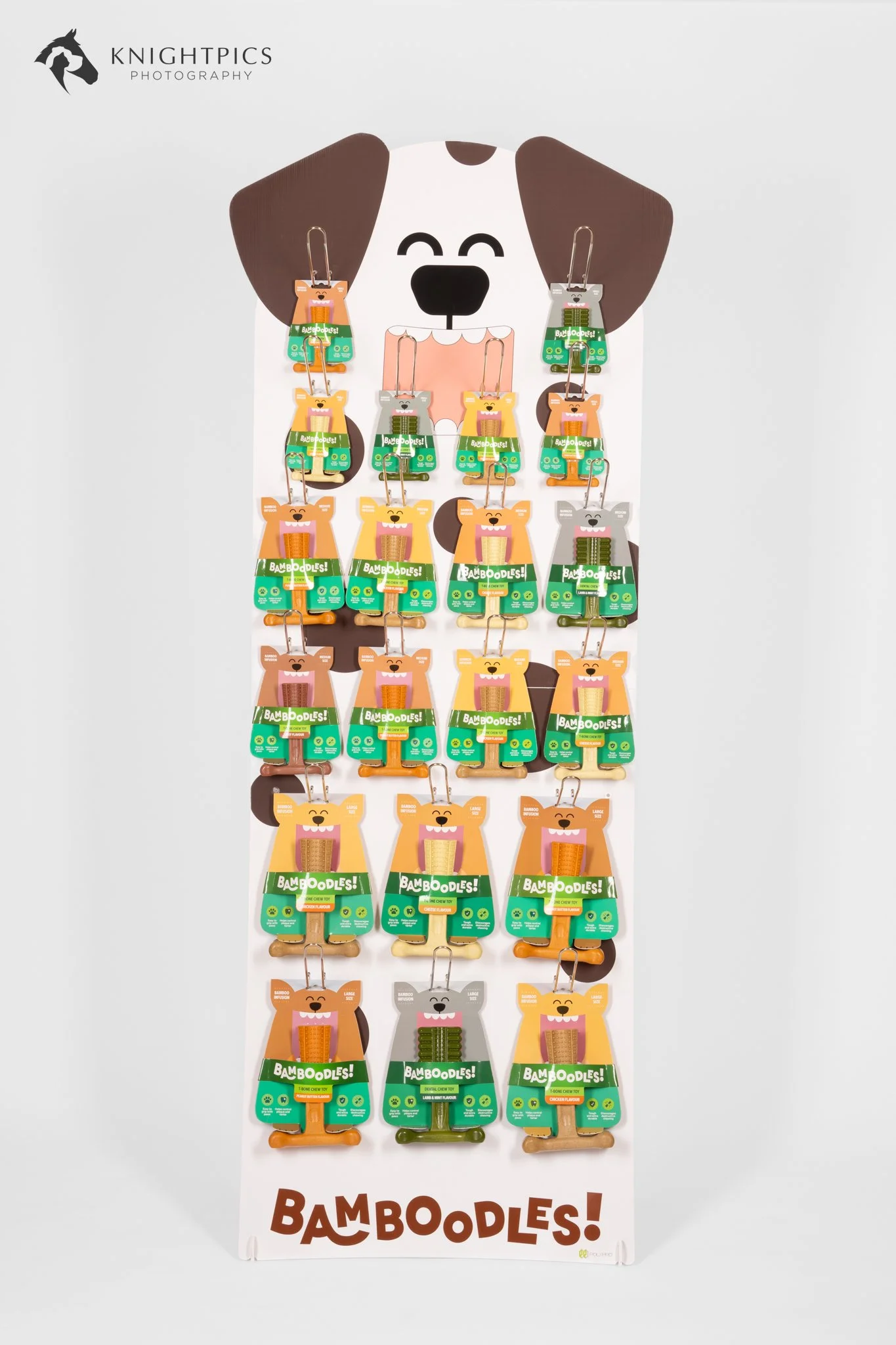 Commercial product photography showing a freestanding Bamboodles retail display stocked with packaged dog chew toys, demonstrating branded point-of-sale presentation for pet shops and retailers.