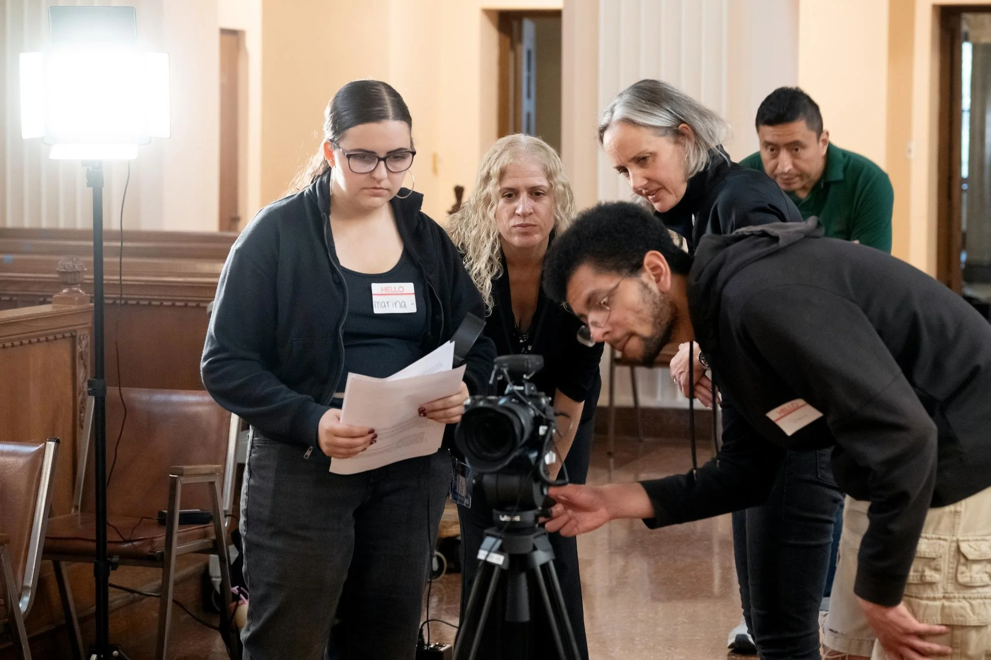   Marina Cilento of Carmel, N.Y., a sophomore Digital Media Production student (left), helps to film the oral history of four Maryknoll Sisters at the congregation’s Center House in Ossining, N.Y.  