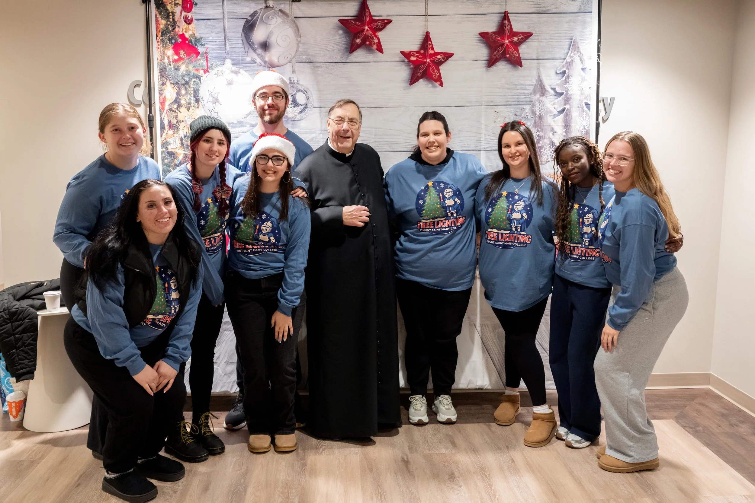   Fr. Gregoire Fluet, Vice President for Mission and Ministry (center), celebrated with students at the annual tree lighting festivities.  