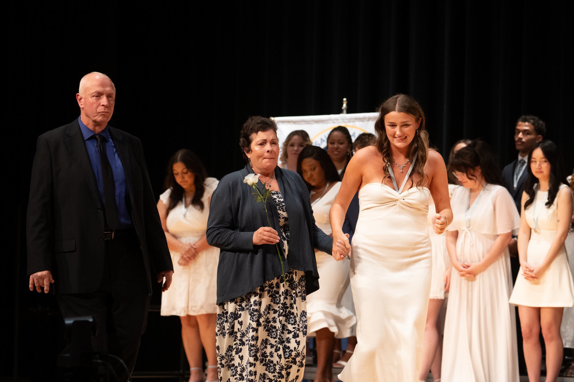 Caitlin Walsh receives her Mount nursing pin from her mother and father on Friday, May 16. 
