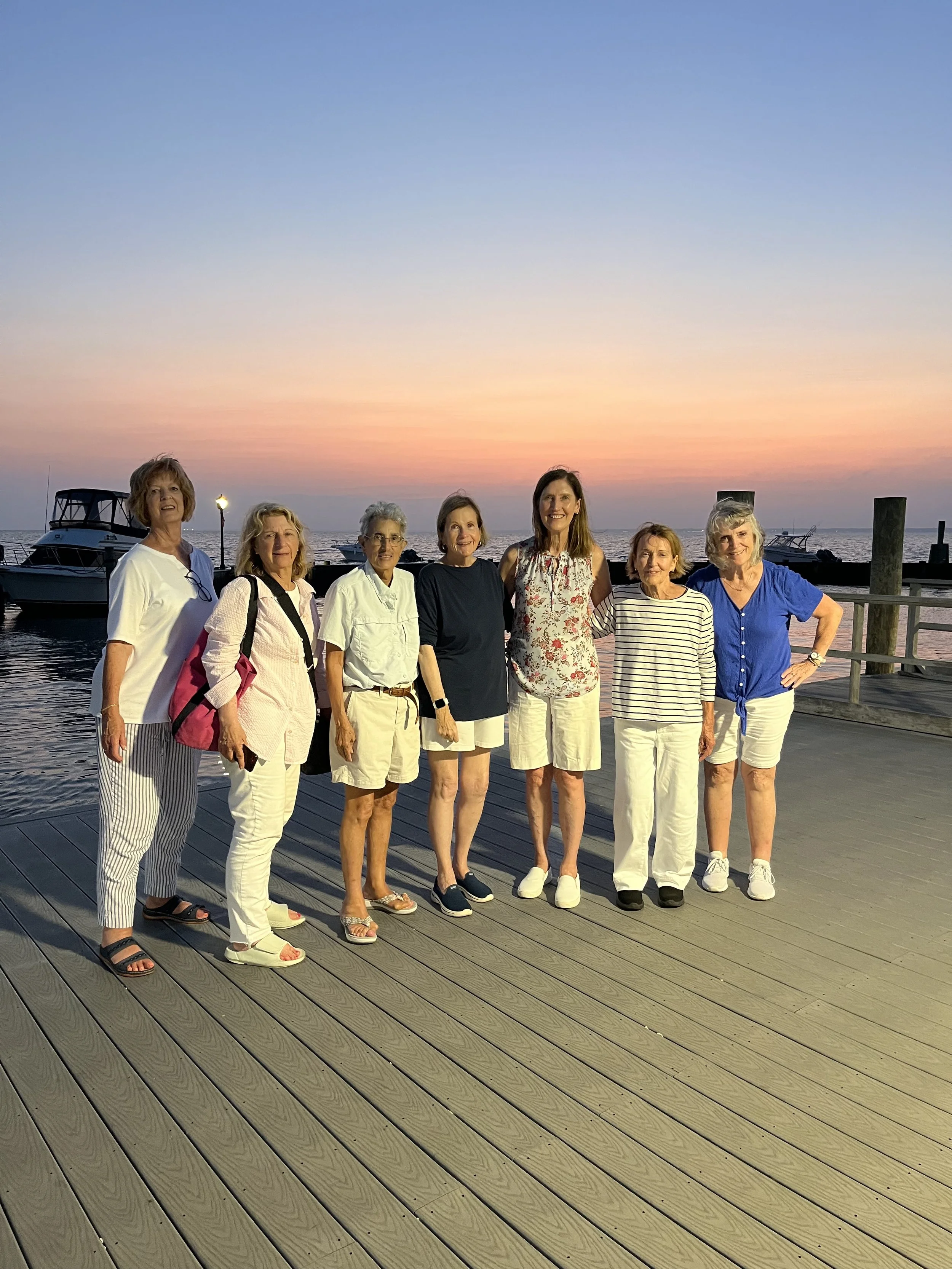 Group of 7 individuals on a pier.