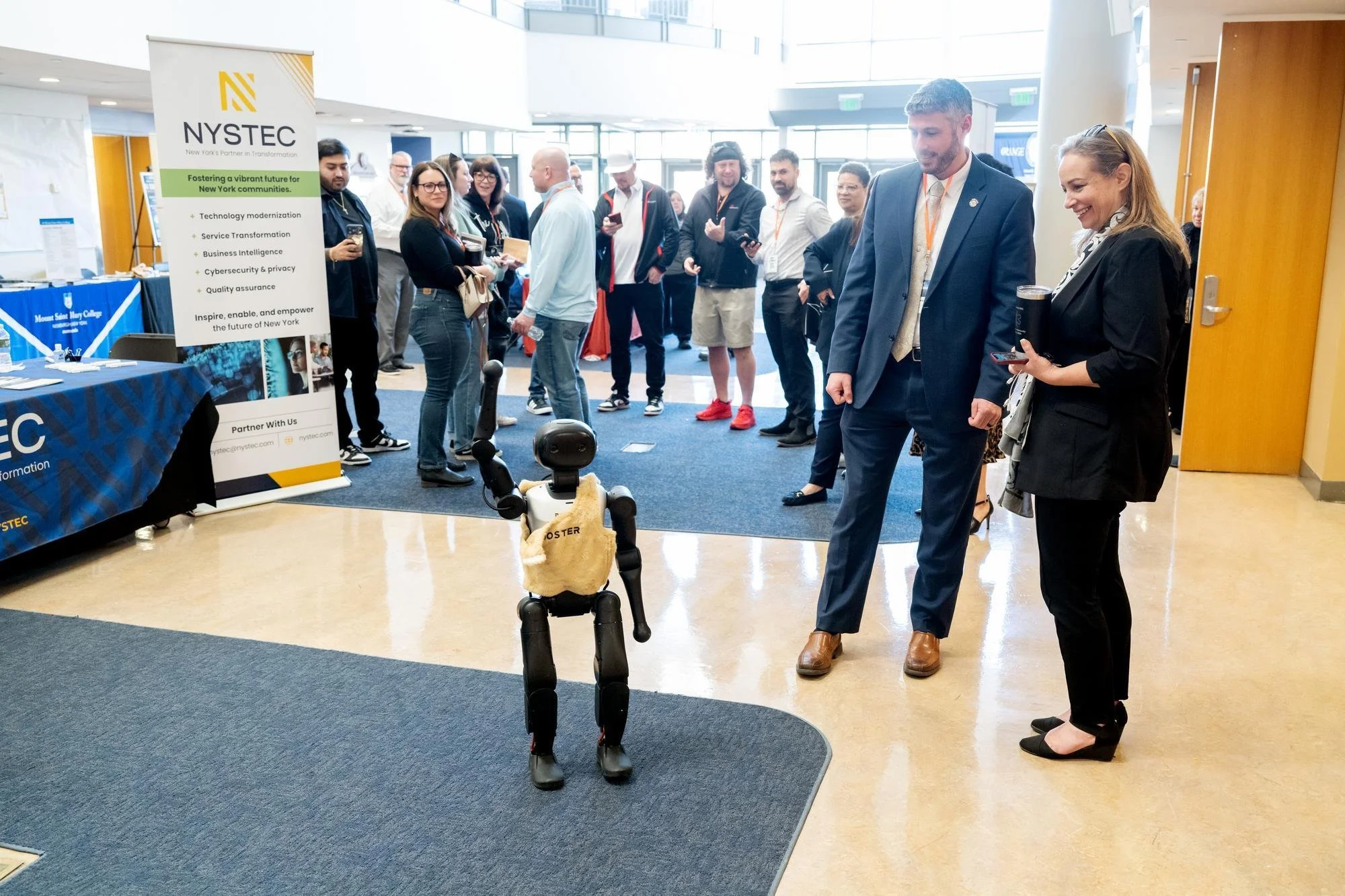   Mobi, a child-sized humanoid AI robot, demonstrates the playful side of autonomous technology by playing soccer for attendees. The summit also featured Sparky, an AI-controlled robotic dog used for emergency management and public safety.  