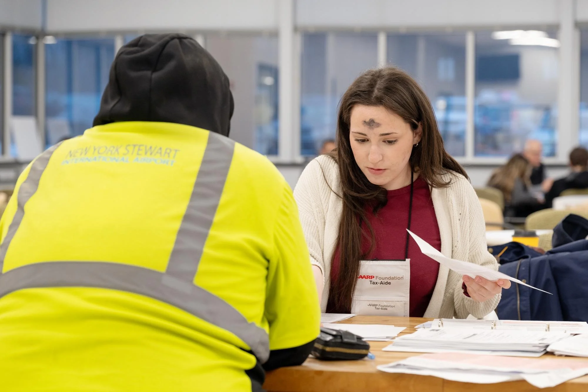   Student Rhiannon T. Petrakis assists a local resident during a Tax-Aide session on Ash Wednesday.  