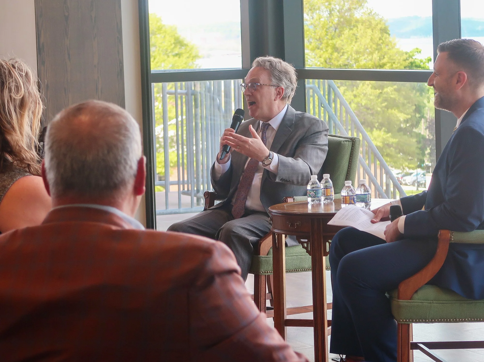 John C. Williams speaks while sitting in the Guzman Hall Multipurpose room.