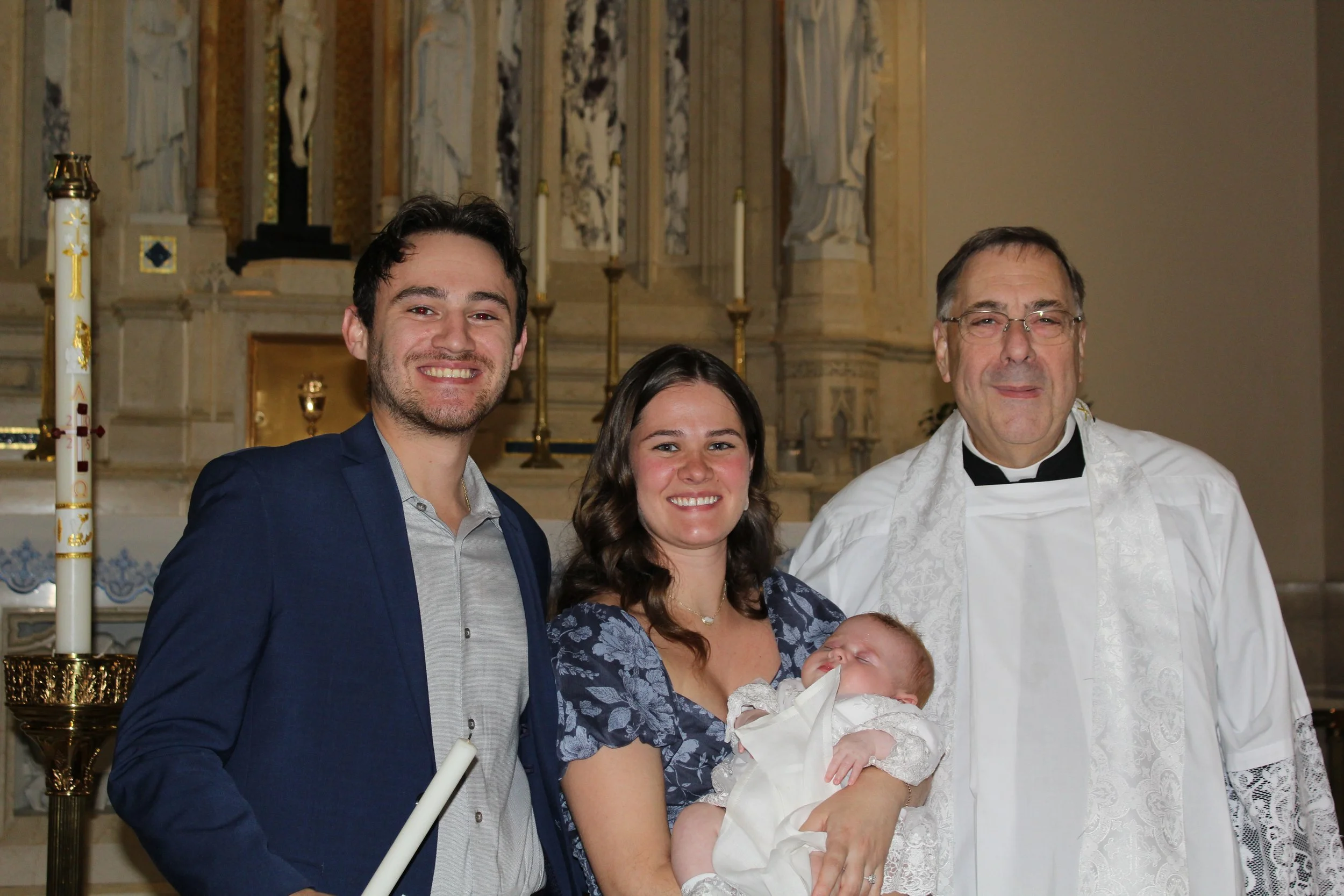 Photo inside the Chapel of the Most Holy Rosary after Fr. Gregoire Fluet, Campus Chaplain, baptized a baby.