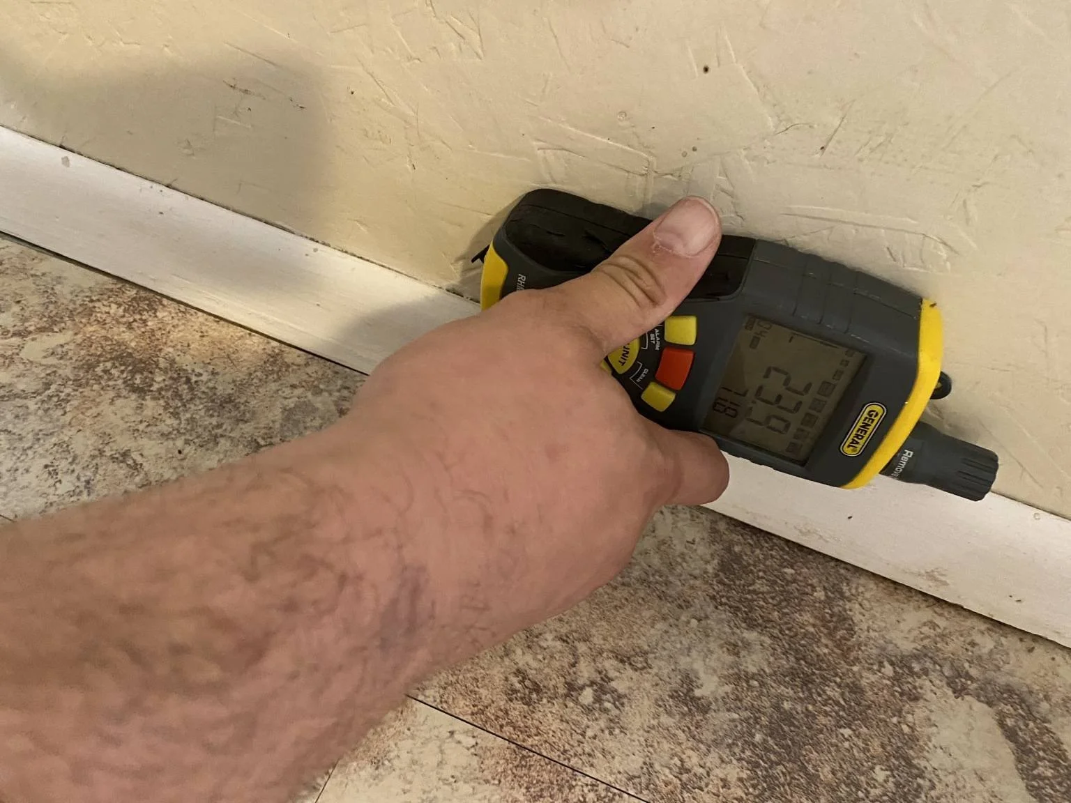 Moisture meter reading during mold inspection in Northbrook IL showing elevated moisture behind wall