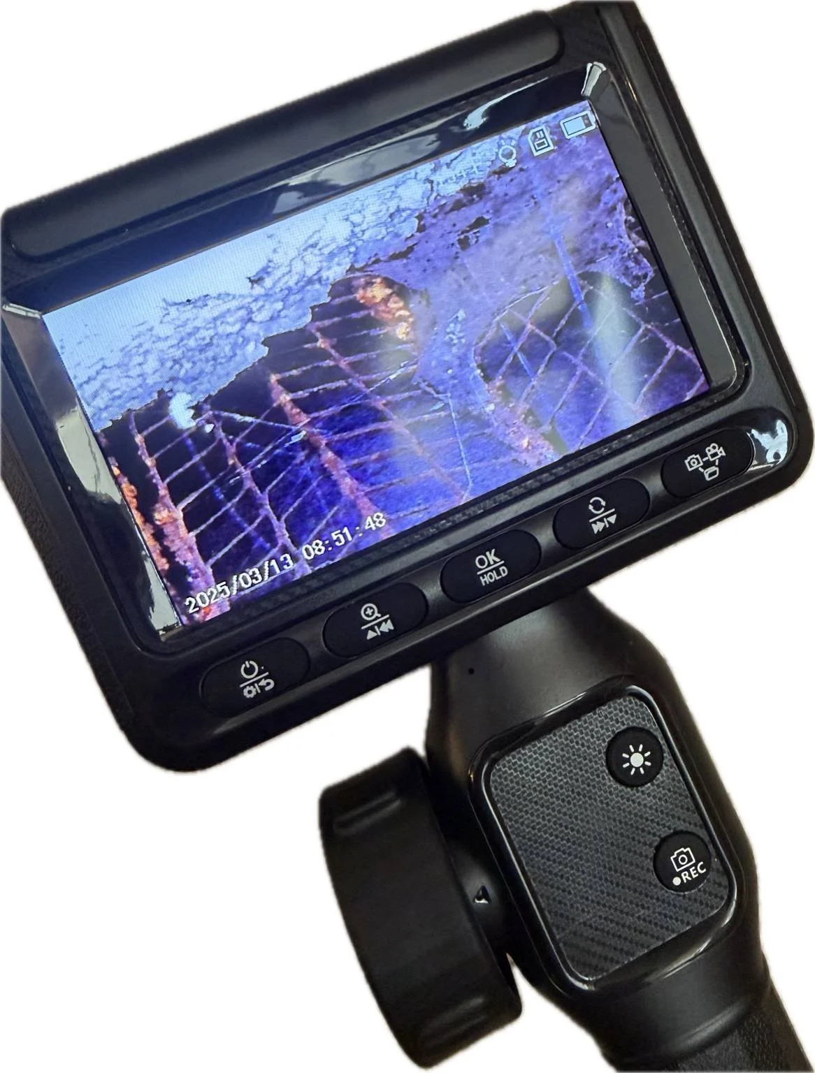 Borescope inspection camera showing hidden moisture and mold conditions inside a wall cavity