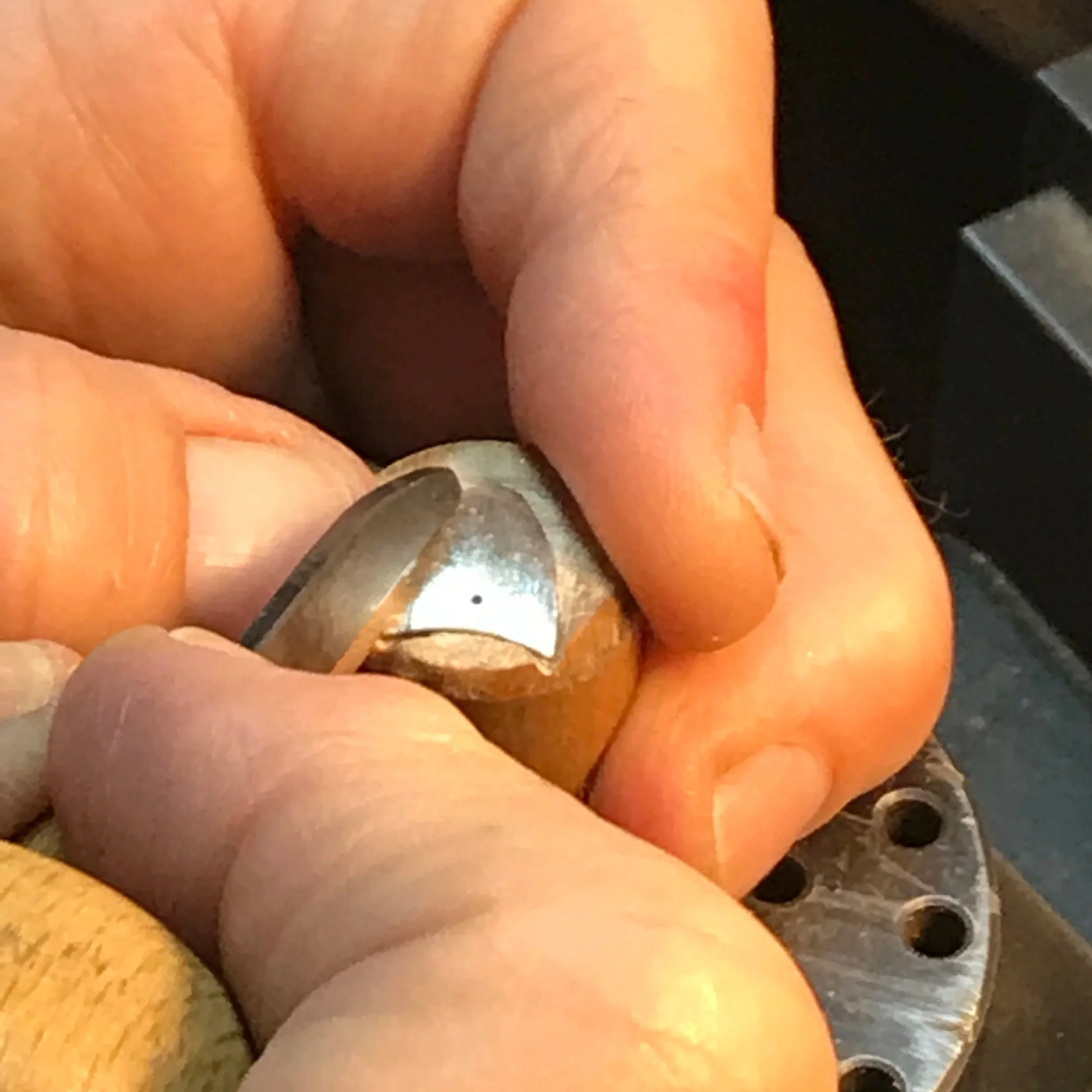 Close up of Siri's hands engraving earring components
