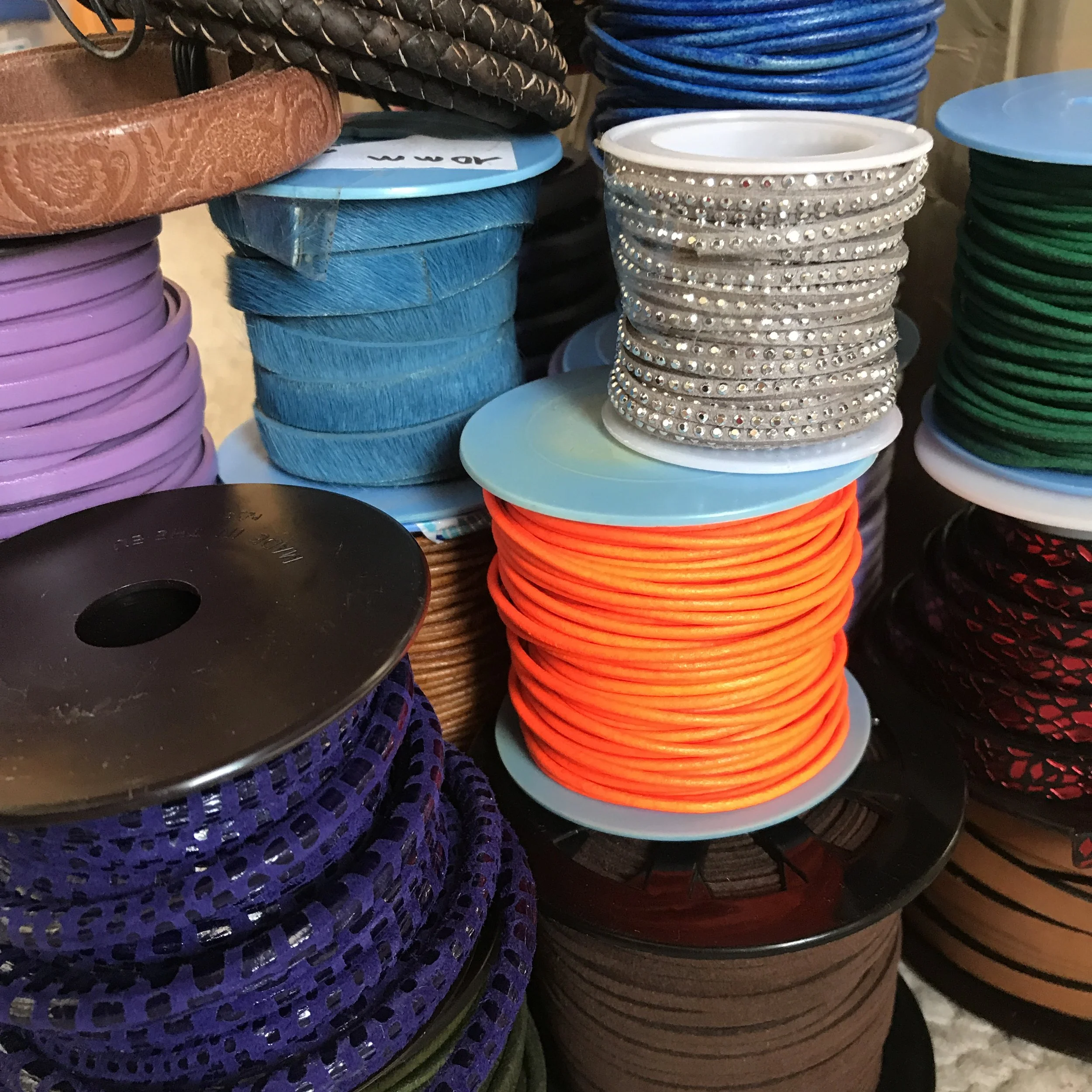 close up of colorful leather spools