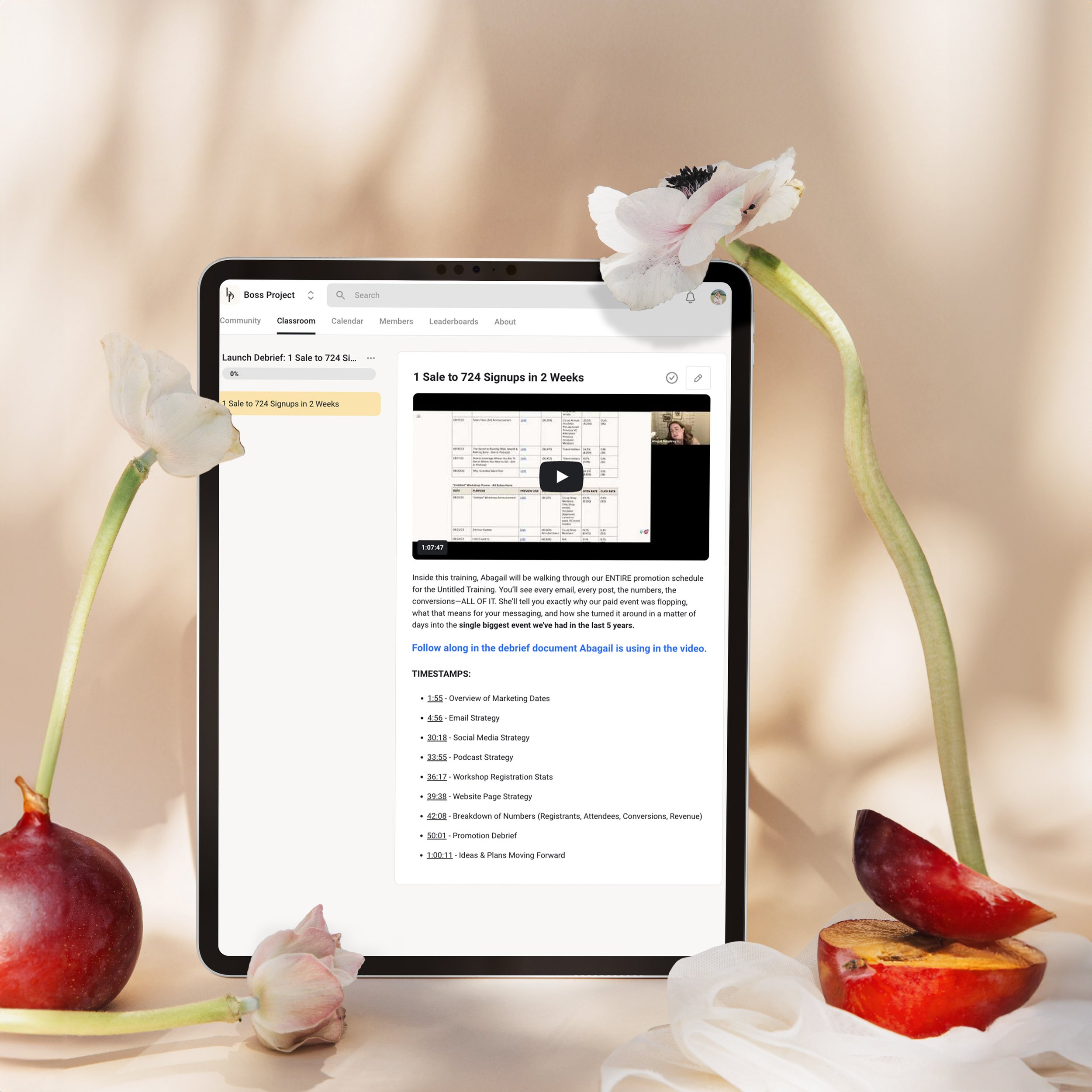 Video player and timestamps on iPad screen with fruit and flowers on table