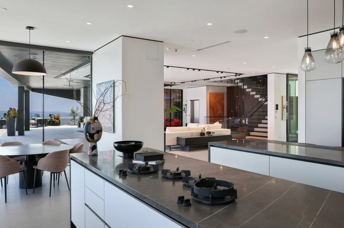 A contemporary kitchen featuring a spacious island and a cozy dining area, designed for functionality and style.