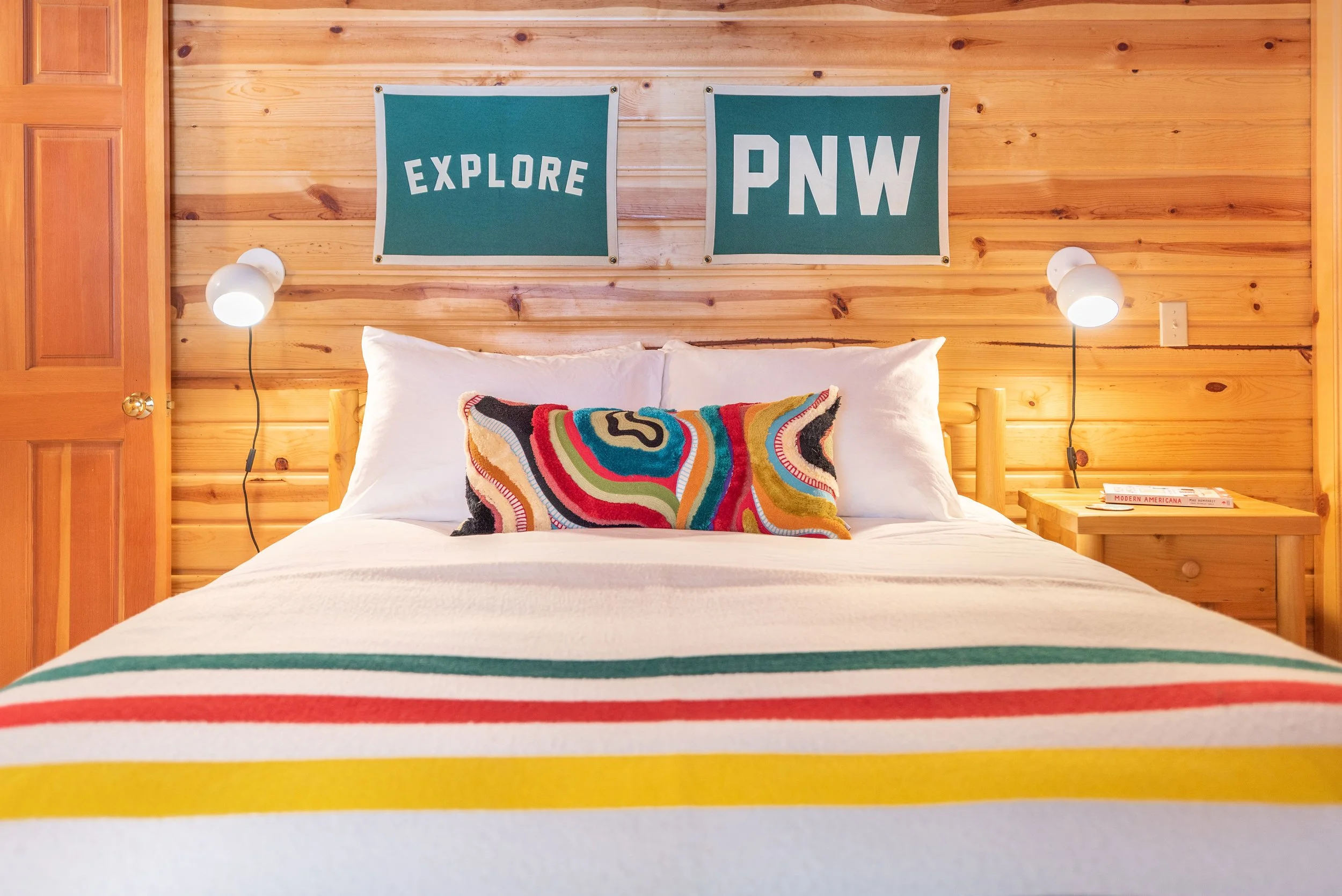 The second guest bedroom features a Pendleton blanket, flags from Budd and Finn of Portland, and our favorite part? This pillow from Yaya & Co.!