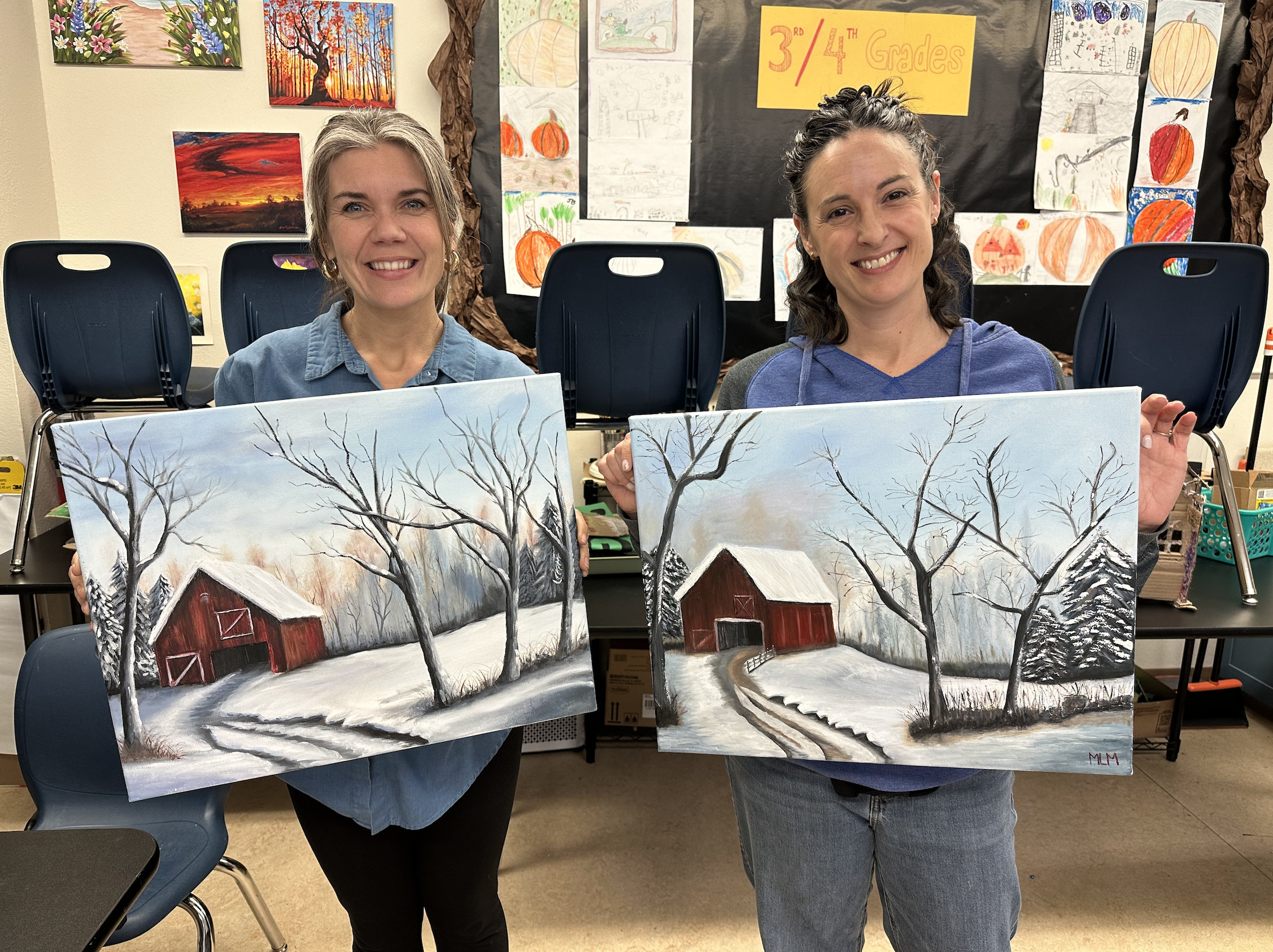 Rocky Lawrence and an adult student holding winter landscape paintings at a Grants Pass art class by Paint Away