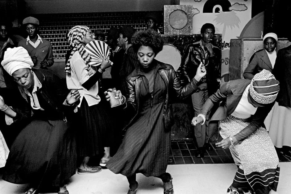 Black and white portrait of Caribbean immigrants dancing to reggae played on a sound system at a church youth disco party in Wolverhampton, England, shot by Chris Steele-Perkins in 1978